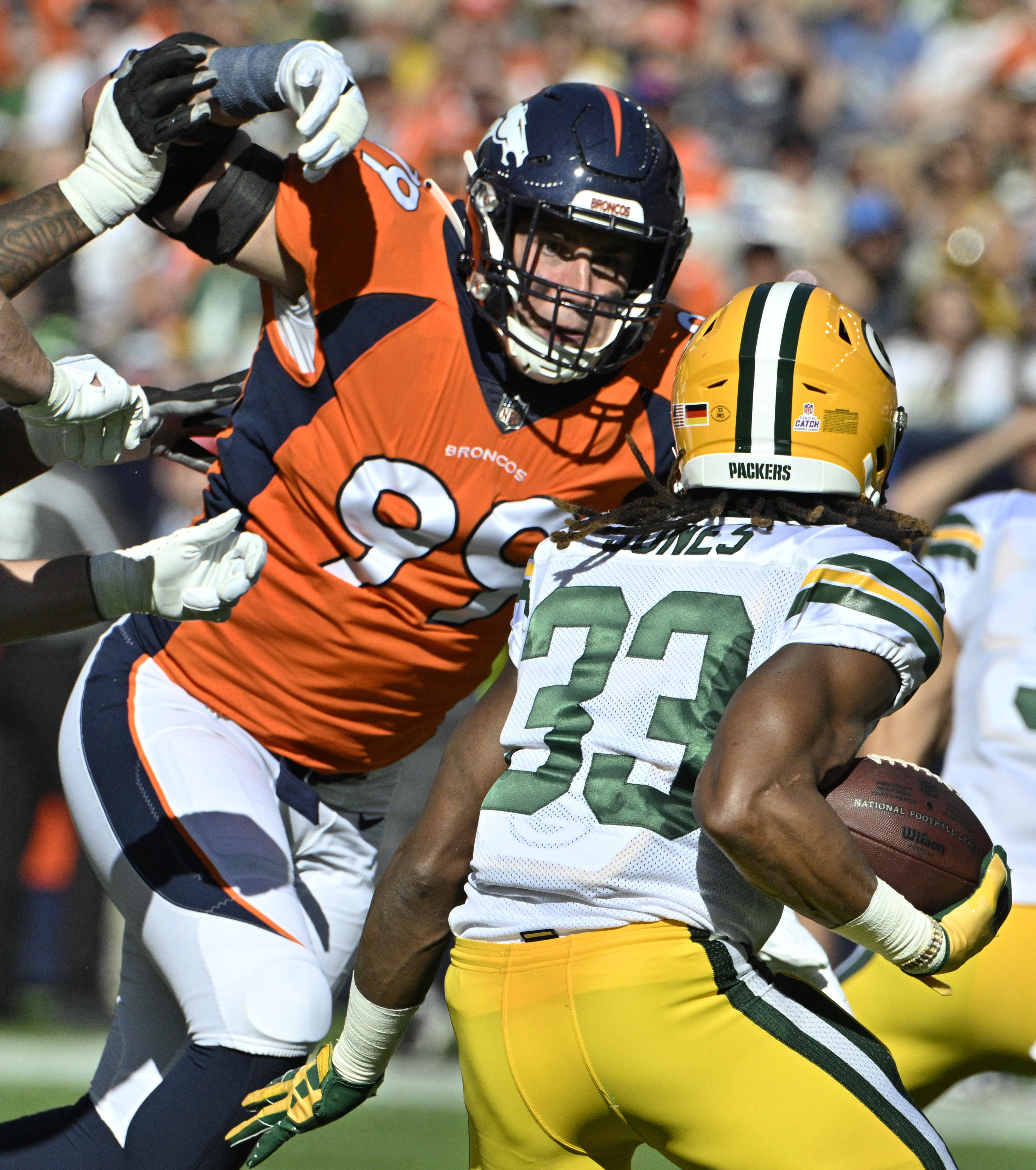 Denver Broncos defensive end Zach Allen (99) looms over Green Bay Packers running back Aaron Jones (33) during a game at Empower Field at Mile High on Sunday, Oct. 22, 2023. (Photo by Jerilee Bennett, The Gazette)