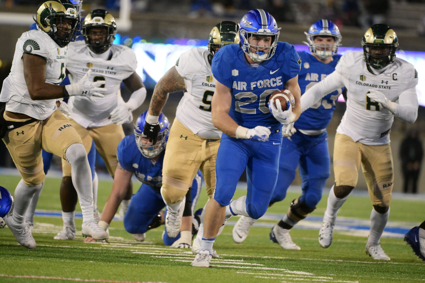 Air Force running back Brad Roberts is followed by the Colorado State defense on the way to a touchdown Nov. 19. (JERILEE BENNETT, THE GAZETTE)