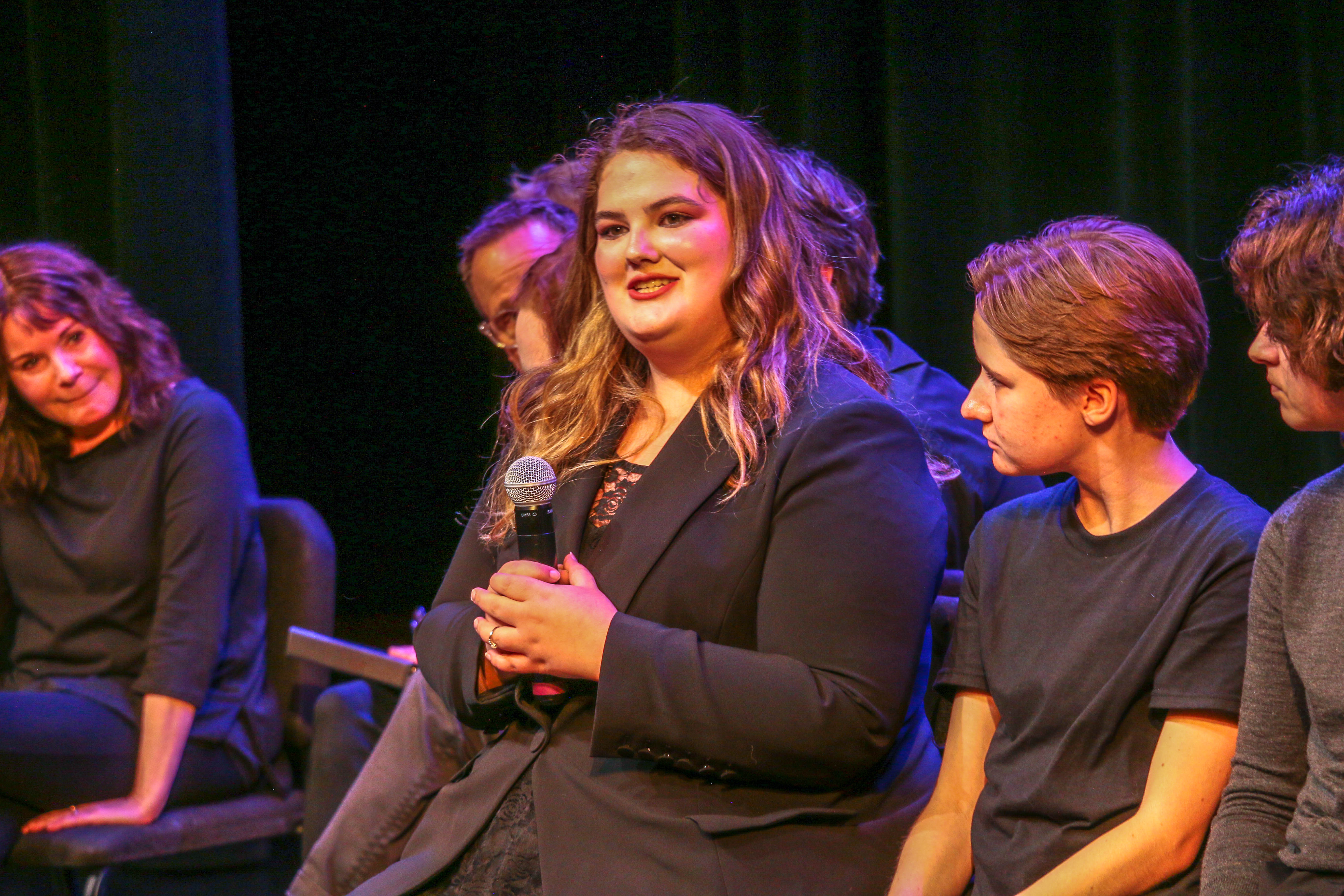A University of Wyoming student who participates in an audience talkback following 'The Laramie Project' 25th anniversary reading with the Tectonic Theater Project in Laramie on Oct. 11, 2023. (JOHN MOORE, DENVER GAZETTE)