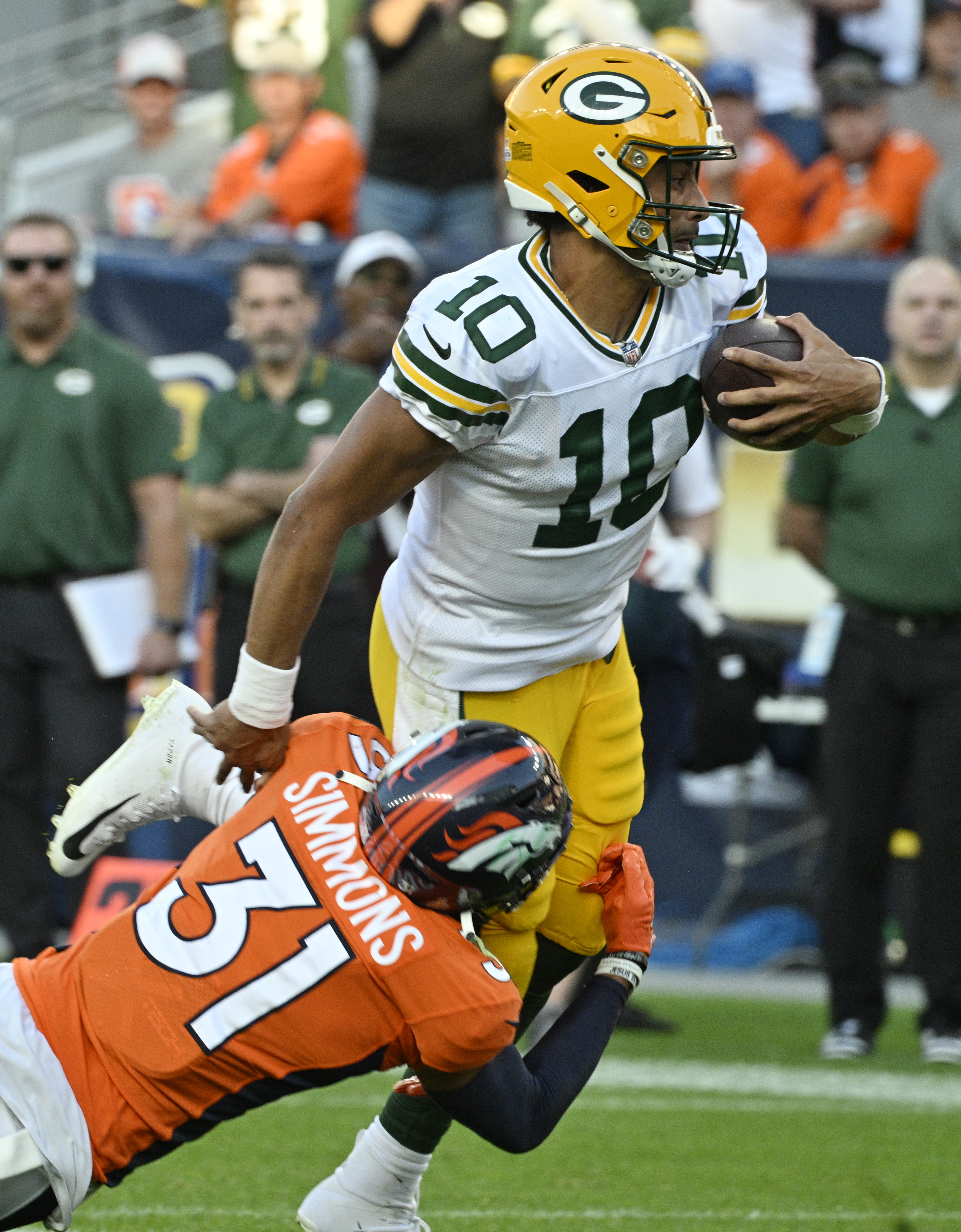 Denver Broncos safety Justin Simmons (31) brings down Green Bay Packers quarterback Jordan Love (10) during a game at Empower Field at Mile High on Sunday, Oct. 22, 2023. (Photo by Jerilee Bennett, The Gazette)