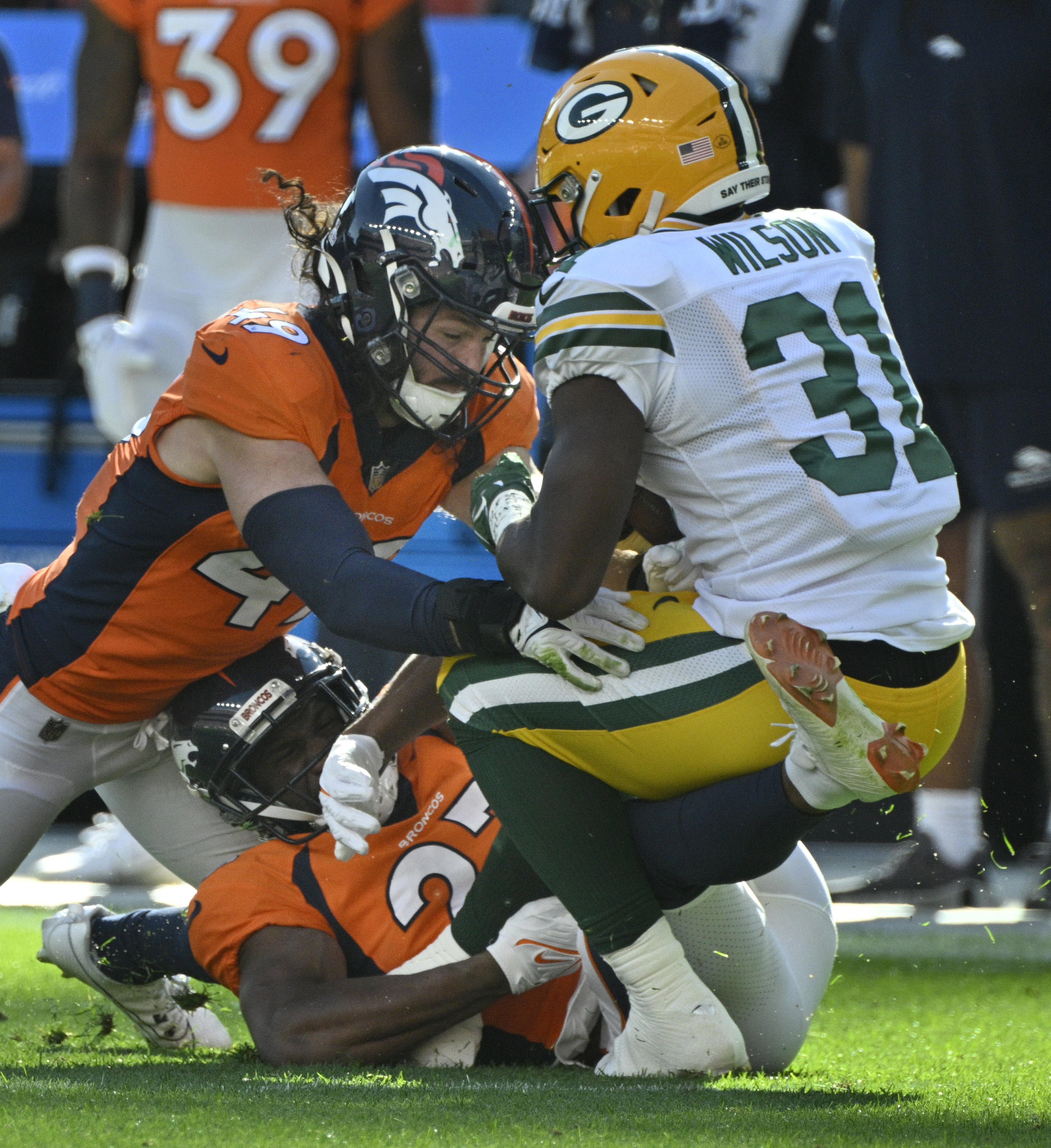 Denver Broncos linebacker Alex Singleton (49) brings down Green Bay Packers running back Emanuel Wilson (31) during a game at Empower Field at Mile High on Sunday, Oct. 22, 2023. (Photo by Jerilee Bennett, The Gazette)