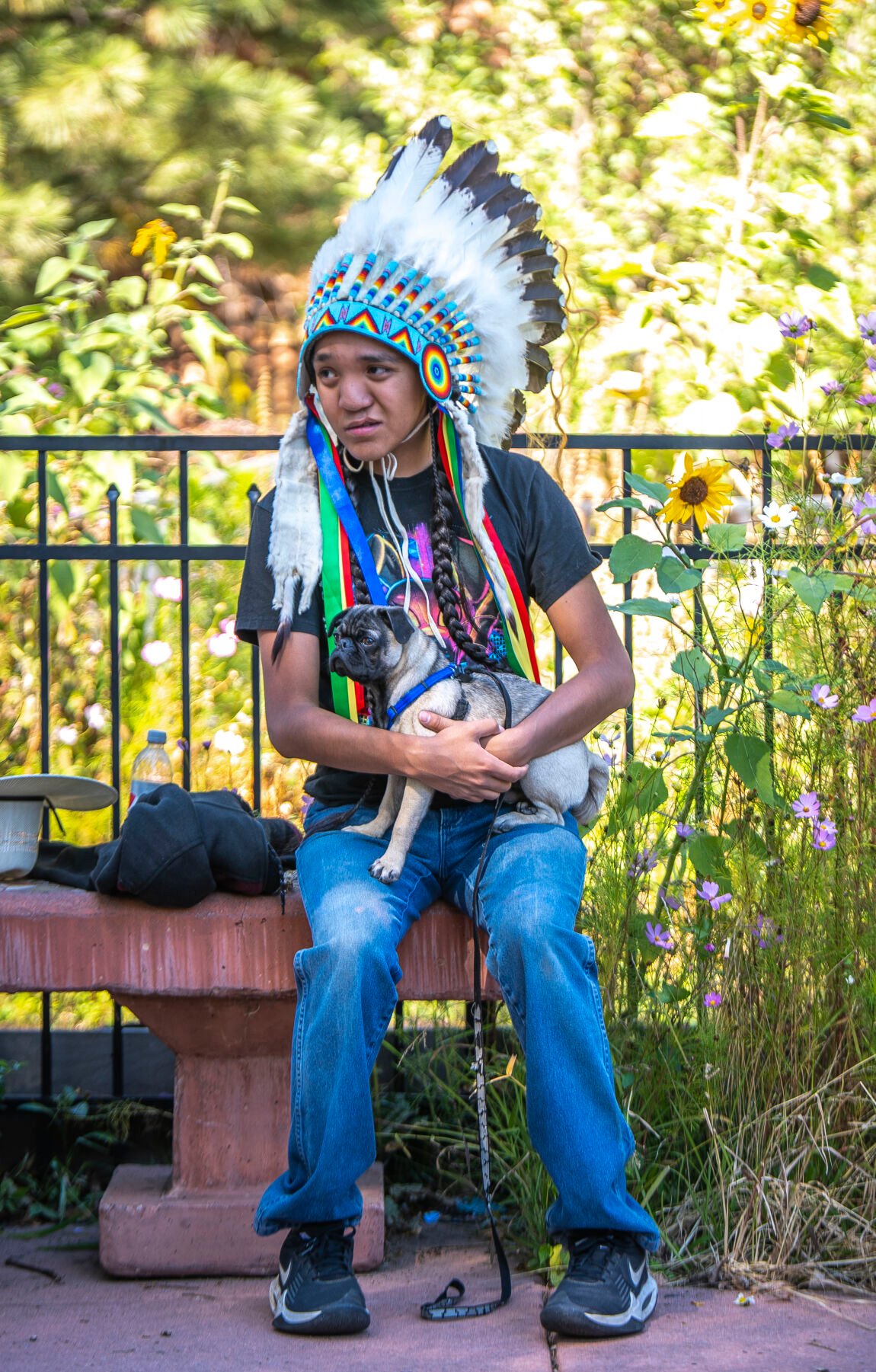 Dowie Howell of the White River Northern Ute holds the family dog at Mansions Park in Manitou Springs, Colo. on Sunday, Oct. 8, 2023. Howell’s family sang an honor song of their ancestors who lived on this land as the blessings of tobacco leaf were cast into the hole the cottonwood ‘Peace Tree’ was placed in moments later. (Gabi Broekema, The Gazette) (Gabi Broekema)
