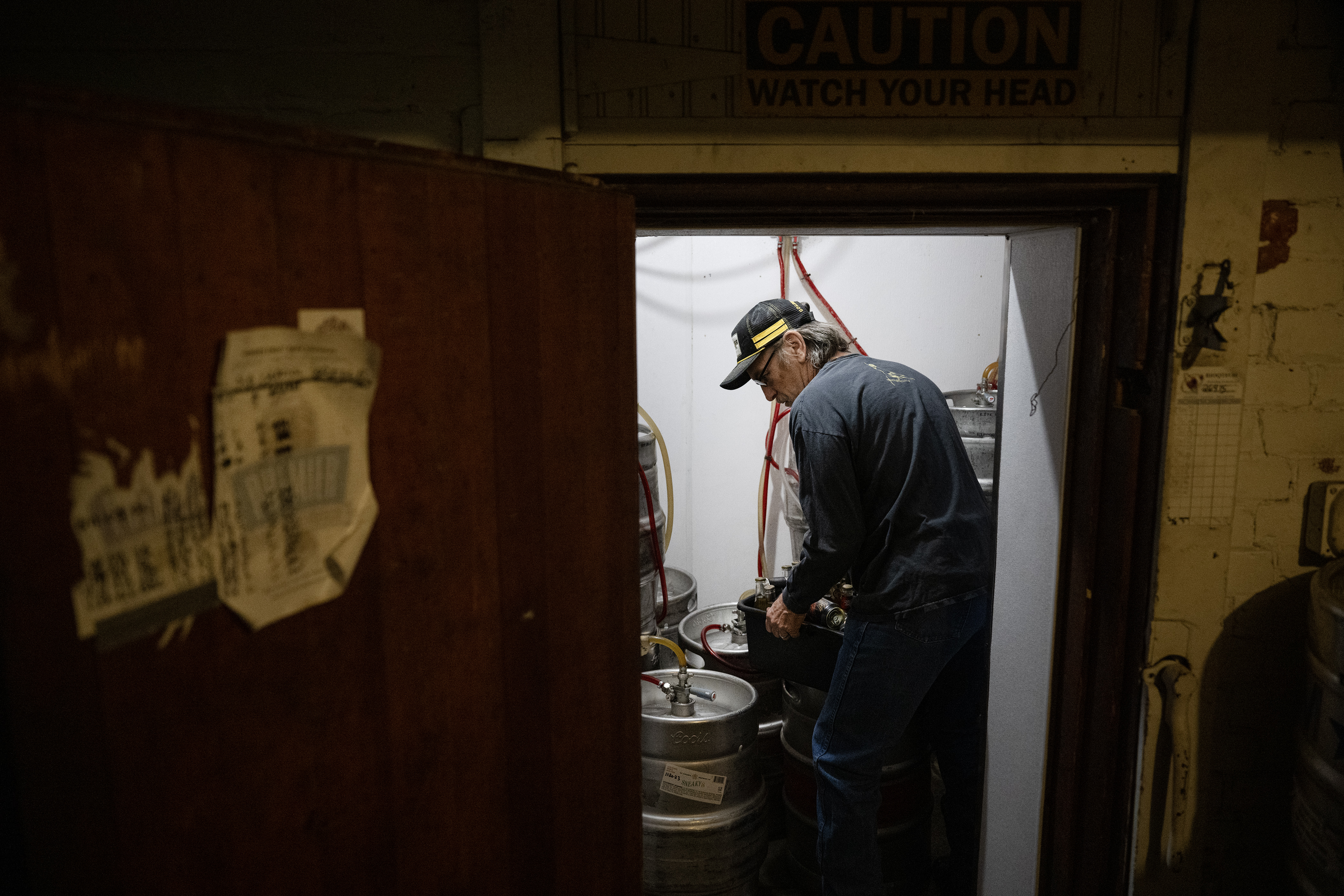 Dean Valdez, a former Coors employee who now owns several bars and restaurants in Golden with his wife Aimee, moves a tub of bottled beer in what is believed to be the original keg cooler in the basement of the Coors Building, now housing one of the Valdez’s restaurants, Old Capitol Grill & Smokehouse, on Tuesday, Oct. 3, 2023, in Golden. The cooler is made from multiple layers of old bricks and has a small hatch above the short entryway to slide blocks of ice in. (Timothy Hurst/Denver Gazette) (TimHursttim.hurst@gazette.comhttps://secure.gravatar.com/avatar/aca82bd62b4ee425c598527cd6faa1b1?d=mm&r=g)