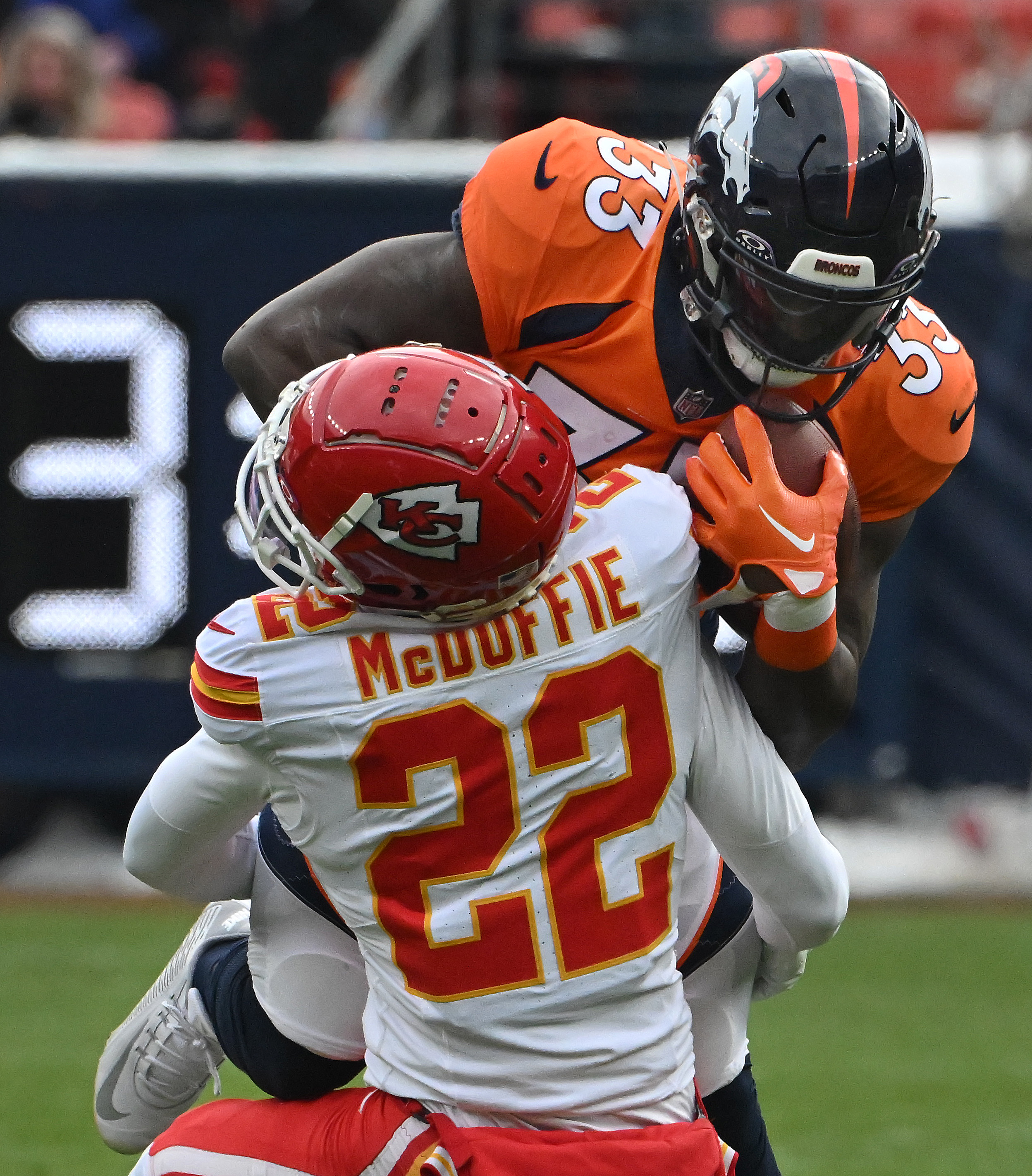 Denver Broncos running back Javonte Williams (33) fights against Kansas City Chiefs cornerback Trent McDuffie (22) during a game at Empower Field at Mile High on Sunday, Oct. 29, 2023. The Broncos won the game 24-9. (Photo by Jerilee Bennett, The Gazette)