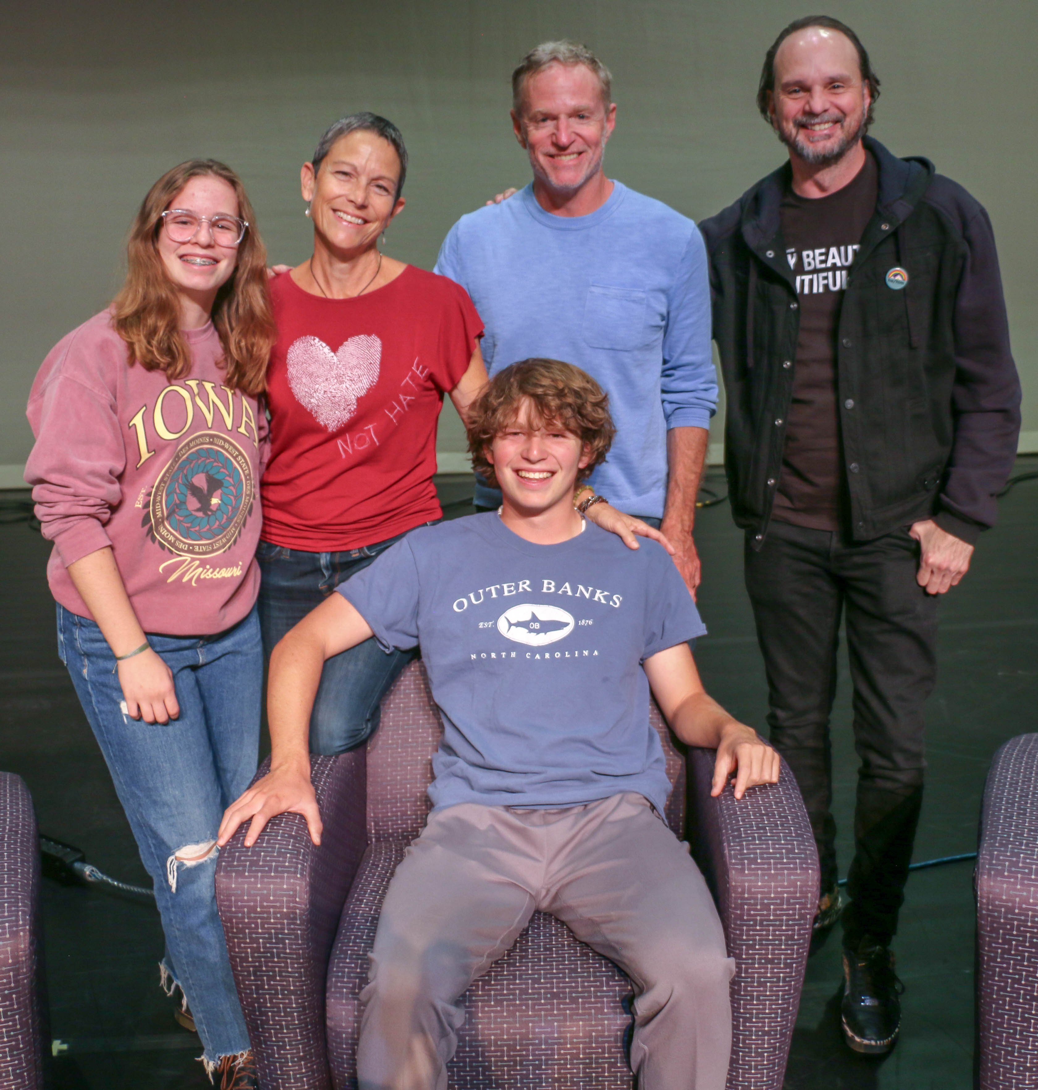 Wyatt Chapman, seated, is a junior at Centaurus High School who drove with his family to Wyoming for Wednesday's activities marking the 25th anniversary of Matthew Shepard's death. Back row, from left: Sister Emily, mother Erica, father Miles and Tectonic Theater Project actor Grant James Varjas. Photo taken Oct. 11, 2023. (JOHN MOORE, DENVER GAZETTE)
