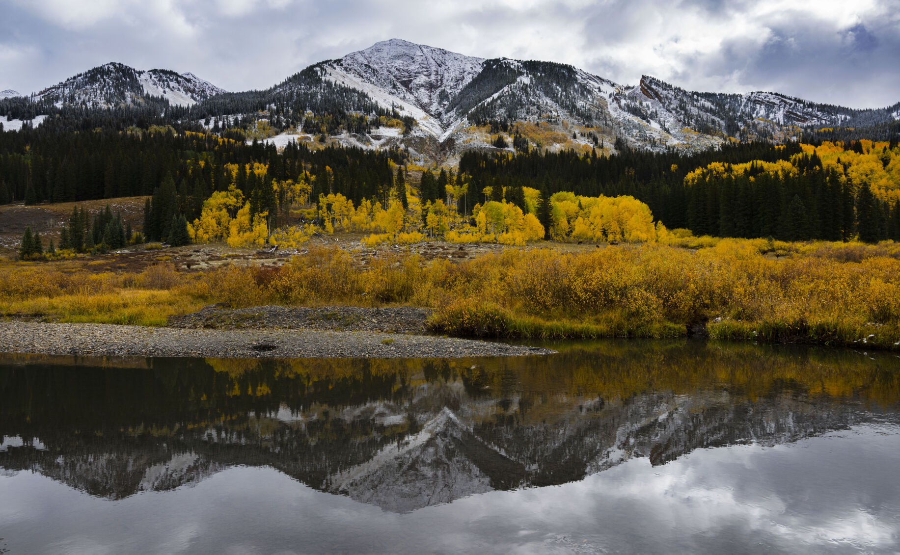 The East River reflects the Elk Mountains and fall foliage near Gothic, Colo., Tuesday, Oct. 3, 2023. (The Gazette, Christian Murdock) (Christian Murdock/The Gazette)
