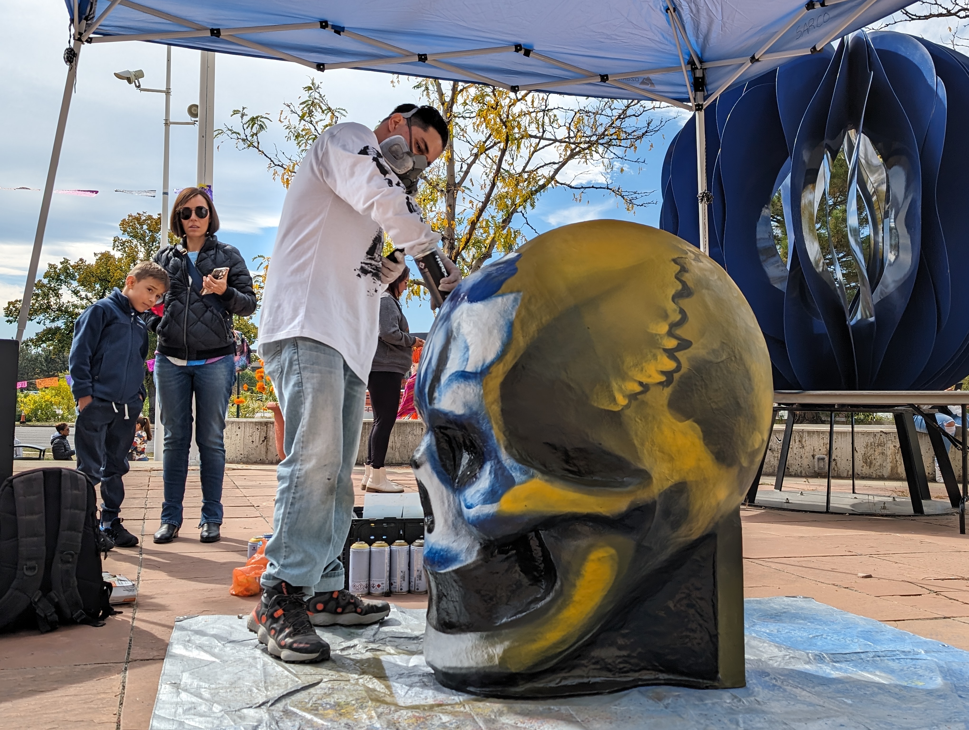 Bimmer Torres — a muralist and sculptor born in Chihuahua, Mexico and raised in Denver — did a live painting of one of his skull sculptures during the event. He is influenced by street graffiti, practicing since he was 15 years old. (SageKelleyJefferson County Reportersage.kelley@denvergazette.comhttps://denvergazette.com/content/tncms/avatars/e/5f/457/e5f45740-2717-11ee-85b2-ab80f2d36252.5b966c1d2ce4987987665d57c237eda4.png)