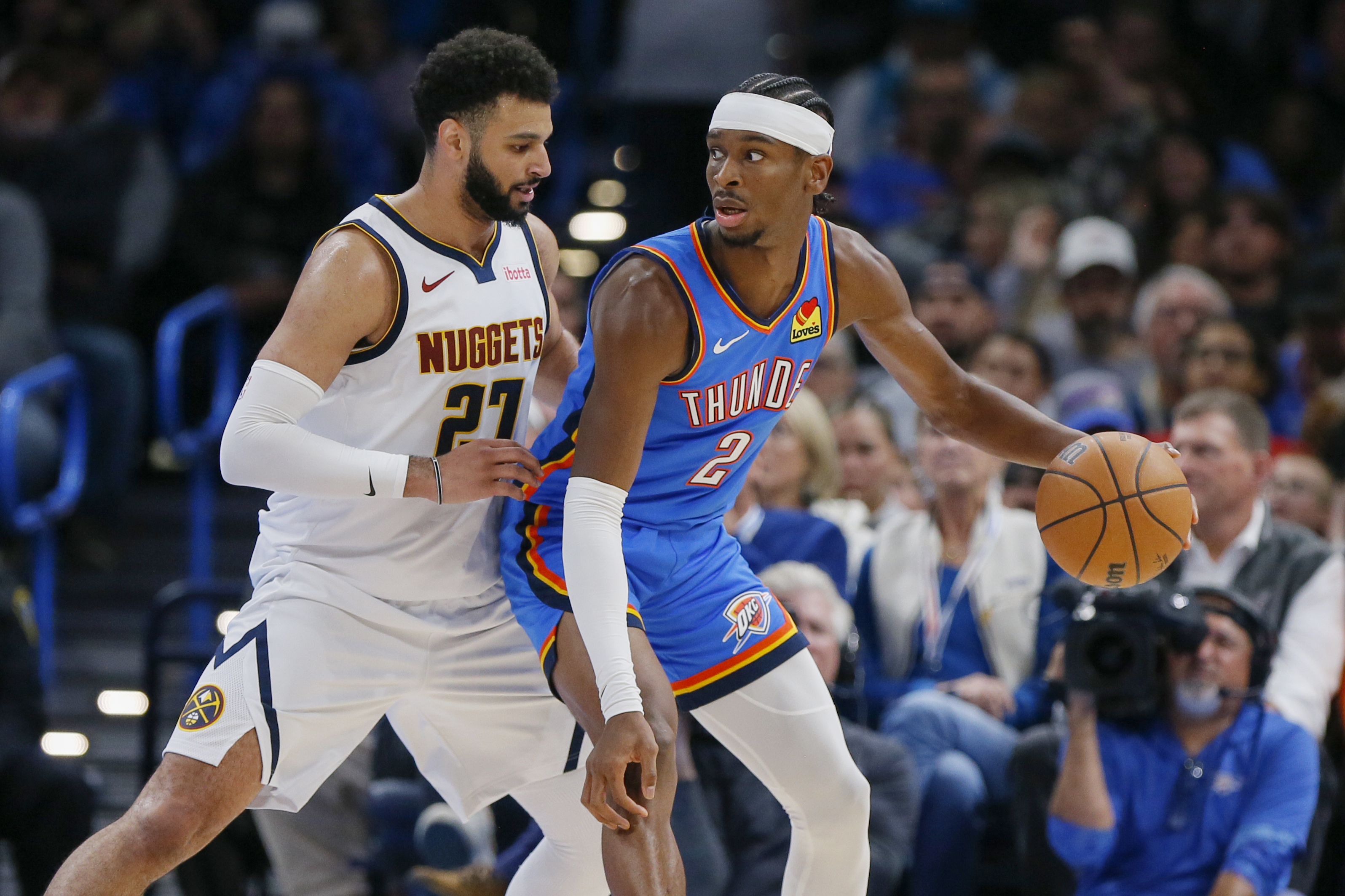 Oklahoma City Thunder guard Shai Gilgeous-Alexander (2) dribbles as Denver Nuggets guard Jamal Murray (27) defends in the first half of an NBA basketball game, Sunday, Oct. 29, 2023, in Oklahoma City. (AP Photo/Nate Billings) (Nate Billings)