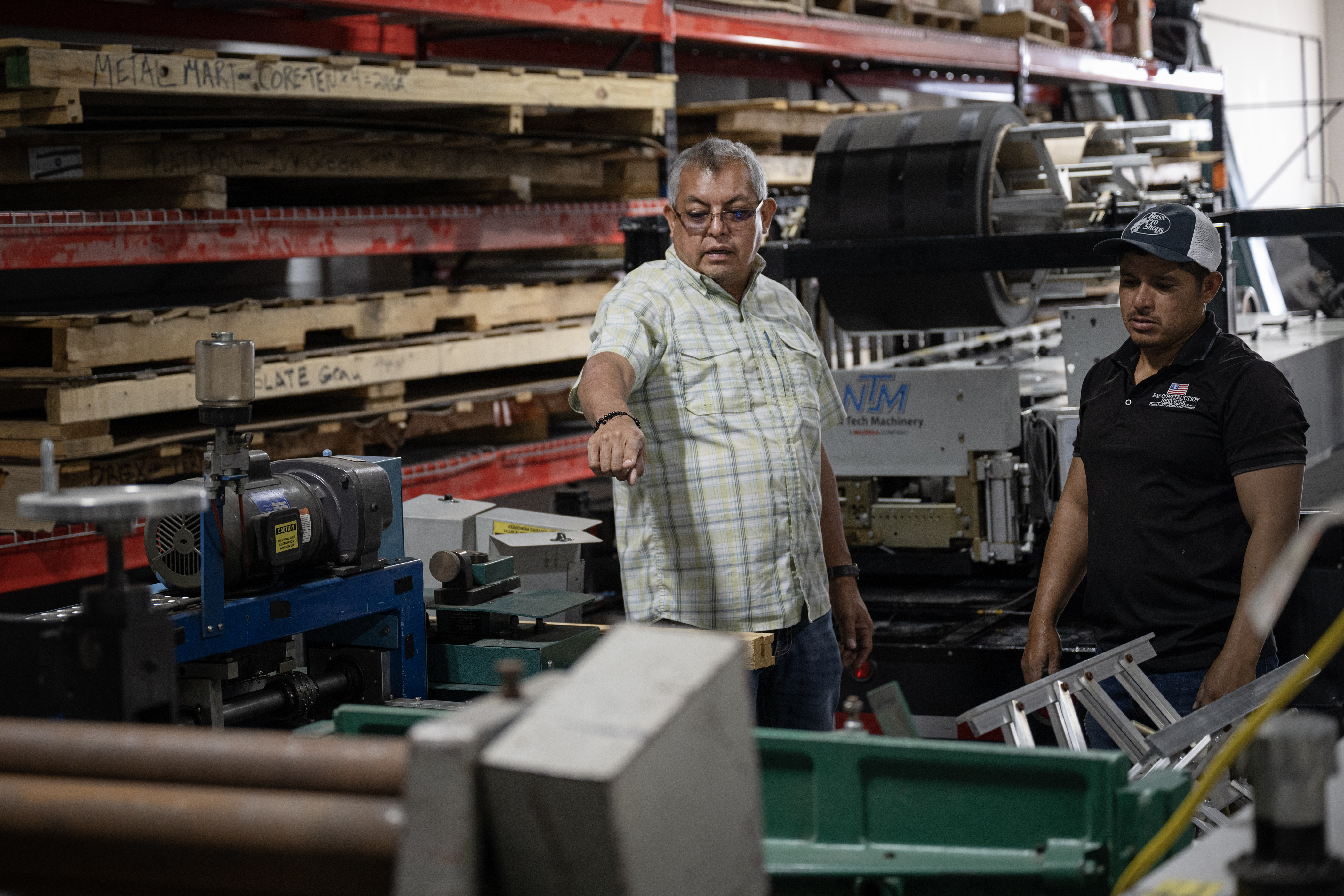 S&S Construction Services COO Sergio Sarabia, left, directs Jesus Alvarado Mendez on where to move heavy equipment around the shop and Sarabia and his wife Gabriela’s second company, Paragon Sheetmetal and Fabrication, on Wednesday, Oct. 11, 2023, in Denver, Colo. (Timothy Hurst/Denver Gazette) (TimHursttim.hurst@gazette.comhttps://secure.gravatar.com/avatar/aca82bd62b4ee425c598527cd6faa1b1?d=mm&r=g)