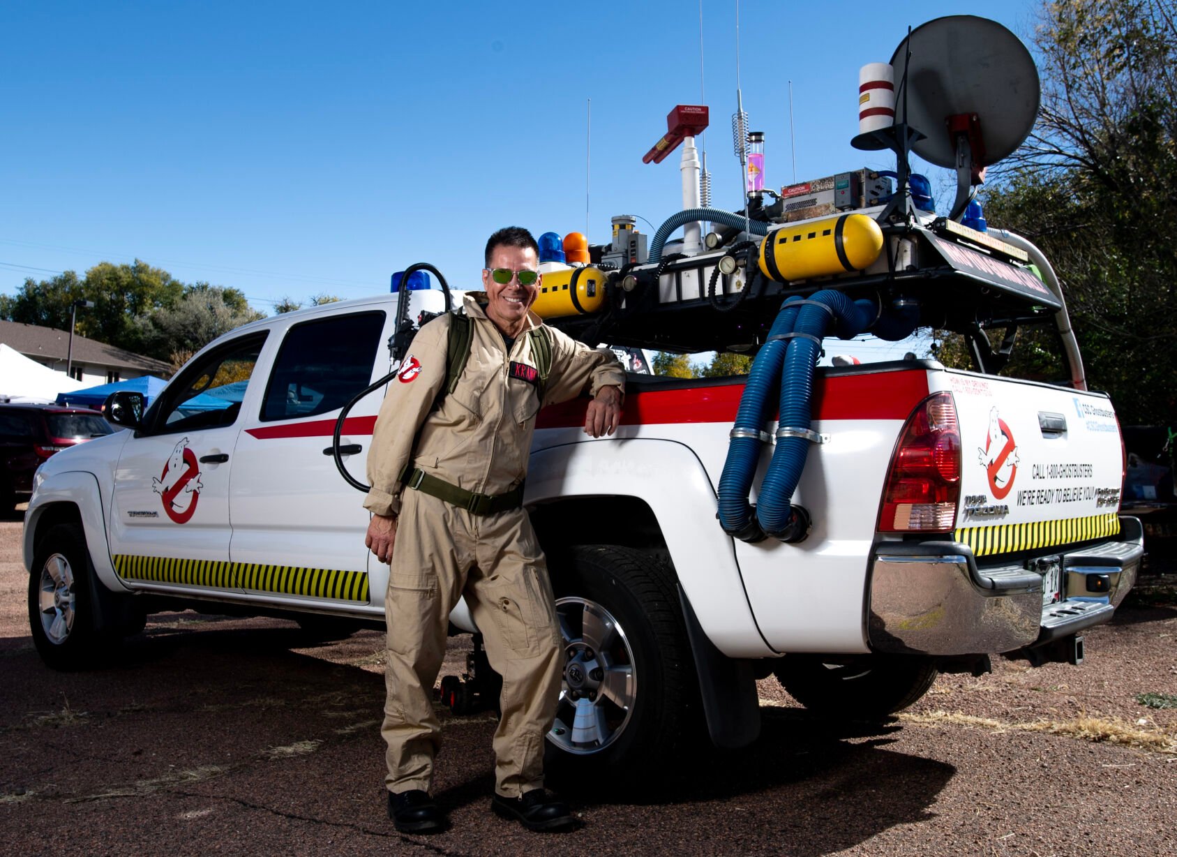 Ken Vizzini, operator of Colorado Springs Ghostbusters, stands next to his Toyota truck that he transformed into a tribute to the Ecto-1 from the film “Ghostbusters.” on Saturday, Oct. 21, 2023“I was bored with my truck,” he says, “and I had always been a ‘Ghostbusters’ fan.” (Parker Seibold, the gazette)