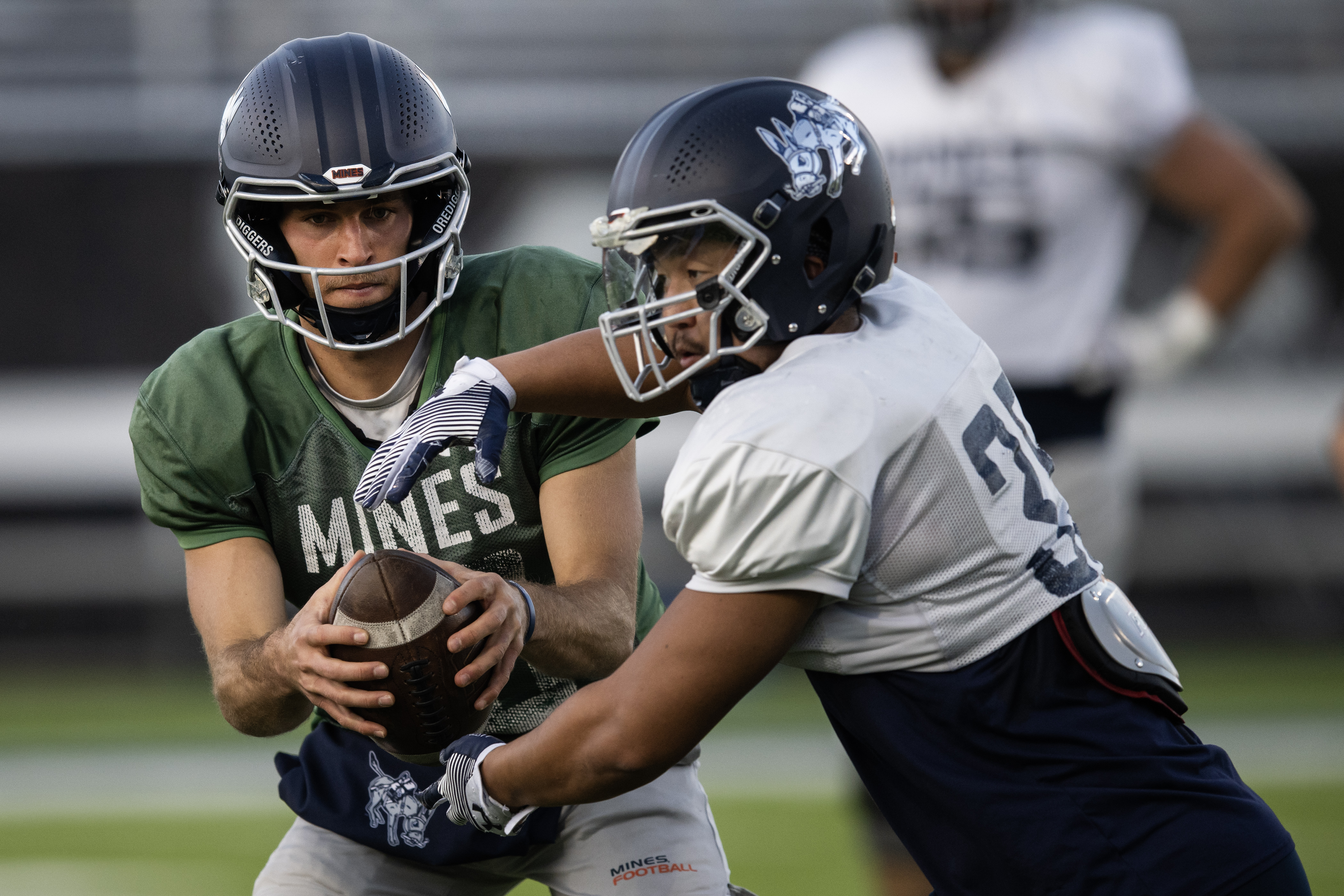 Colorado School of Mines redshirt senior quarterback John Matocha (10) fakes the handoff to redshirt junior running back Chris Yoo (35) during a two-minute drill at practice on Wednesday, Oct. 25, 2023, at Marv Kay Stadium in Golden, Colo. (Timothy Hurst/Denver Gazette) (TimHursttim.hurst@gazette.comhttps://secure.gravatar.com/avatar/aca82bd62b4ee425c598527cd6faa1b1?d=mm&r=g)