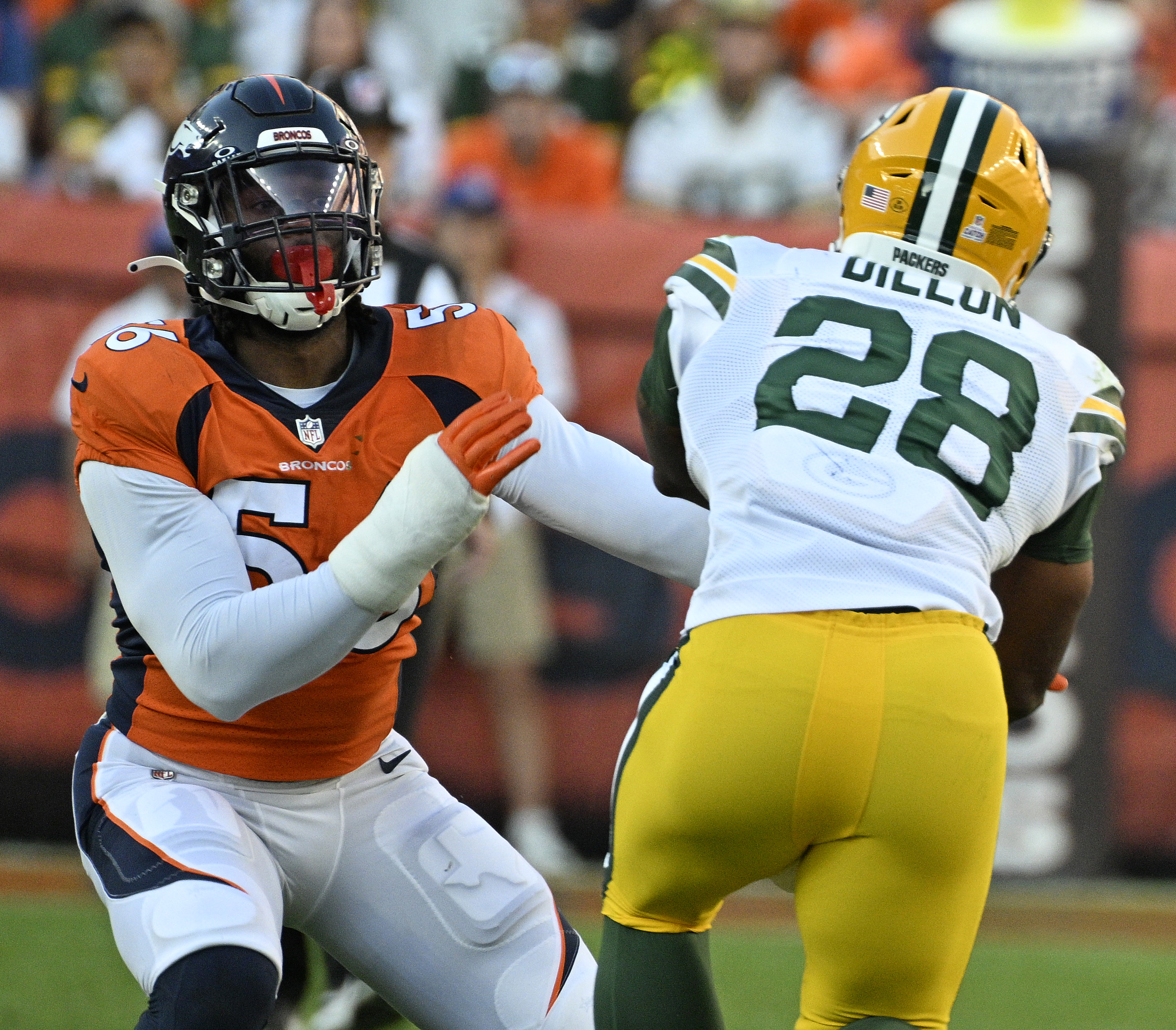 Denver Broncos linebacker Baron Browning (56) goes after Green Bay Packers running back AJ Dillon (28) during a game at Empower Field at Mile High on Sunday, Oct. 22, 2023. (Photo by Jerilee Bennett, The Gazette)