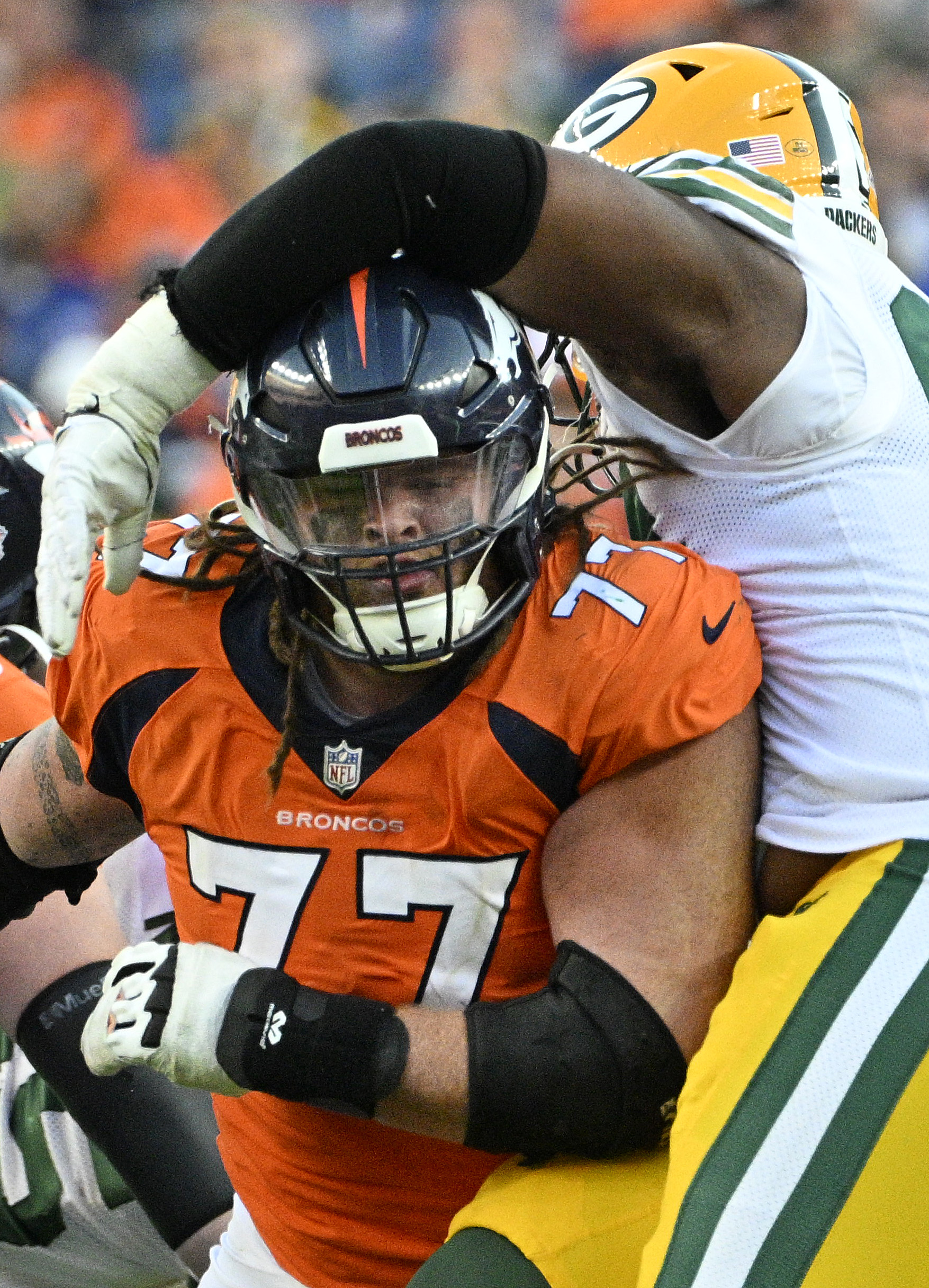 Denver Broncos guard Quinn Meinerz (77) gets tangled up with a Packers defensive player during a game at Empower Field at Mile High on Sunday, Oct. 22, 2023. (Photo by Jerilee Bennett, The Gazette)