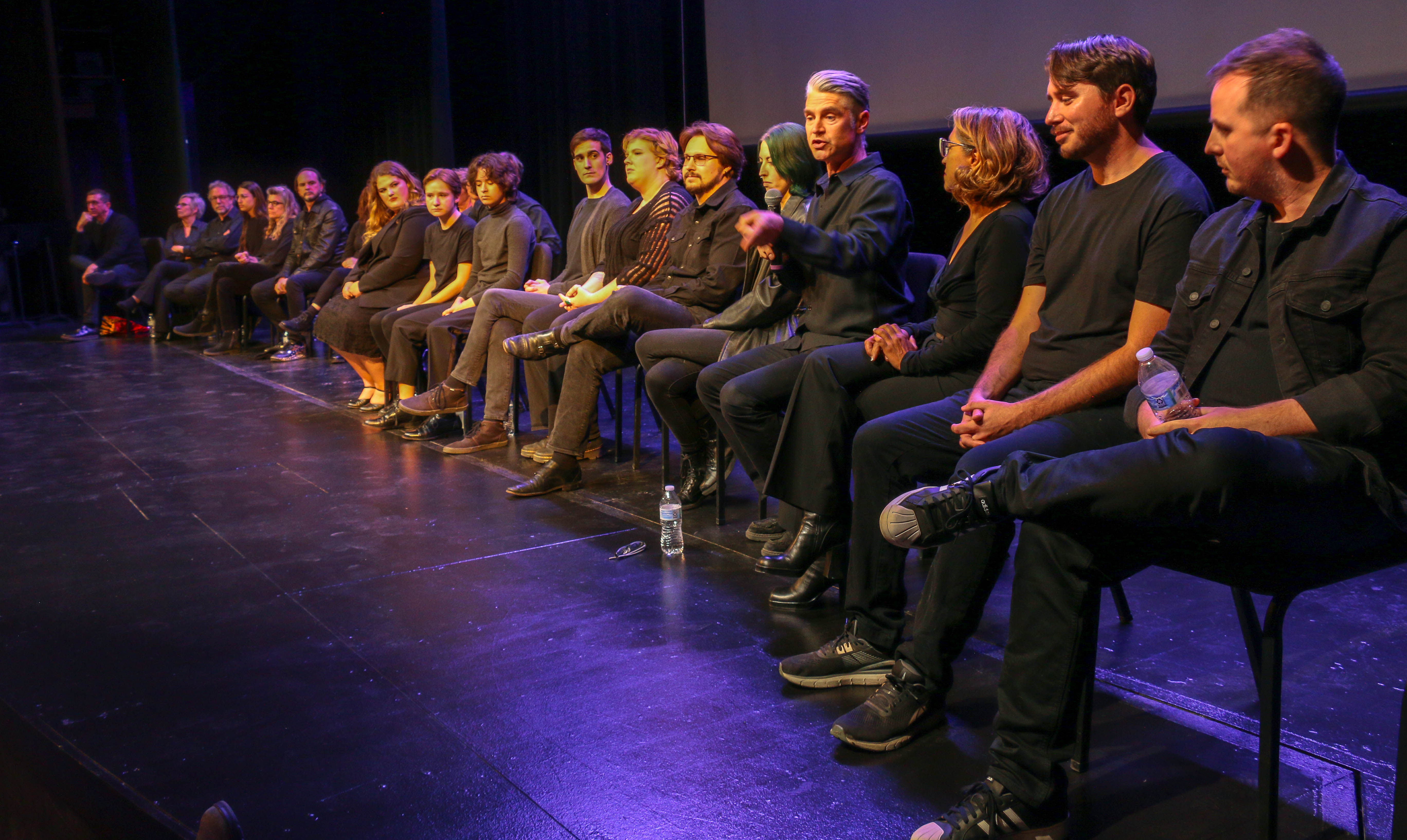 The audience talkback following 'The Laramie Project' 25th anniversary reading with the Tectonic Theater Project in Laramie on Oct. 11, 2023. Speaking is company member Scott Barrow, fourth from right. (JOHN MOORE, DENVER GAZETTE)
