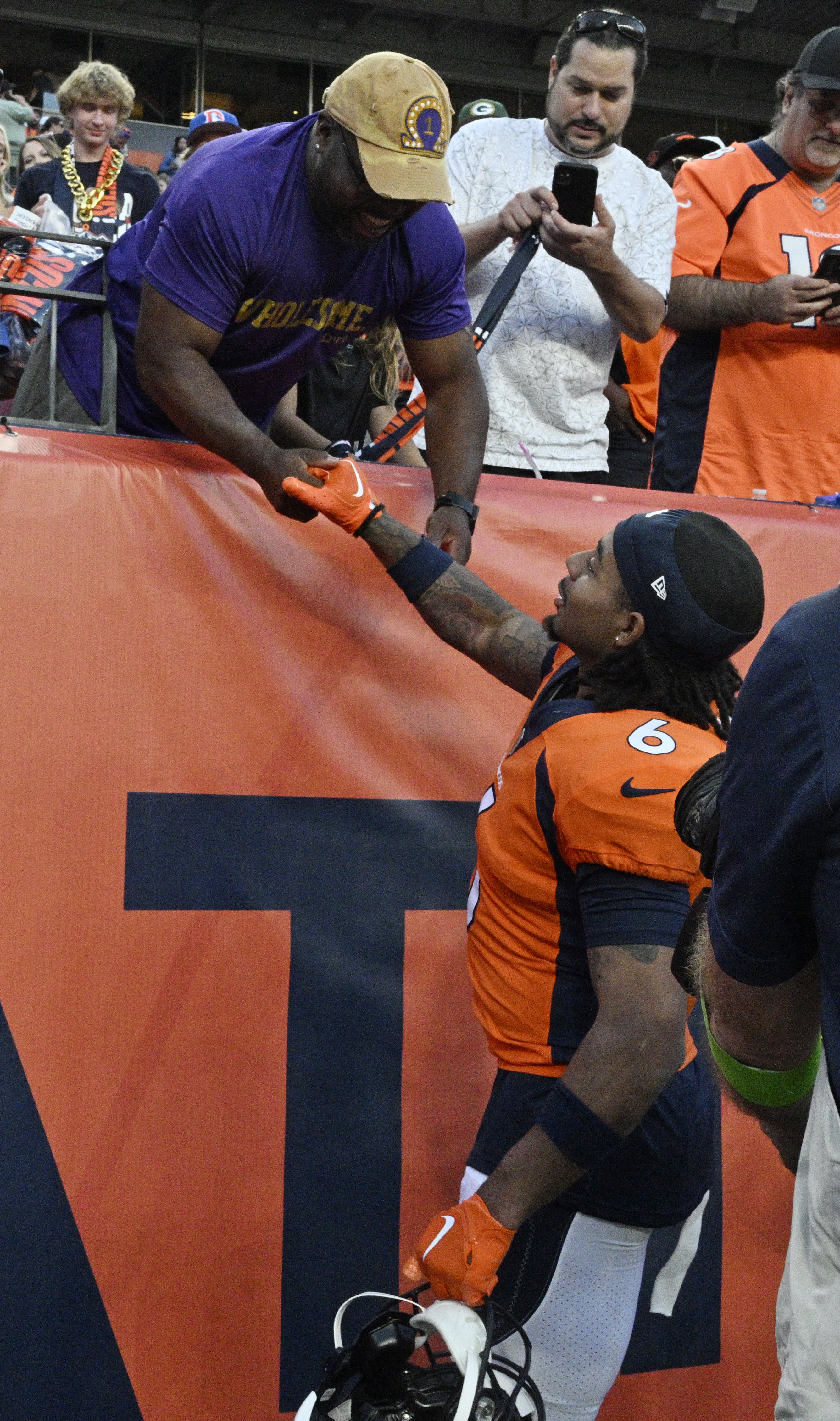 Broncos safety PJ Locke III celebrates with his uncle Eric Tippins after game in which he got the winning interception at Empower Field at Mile High on Sunday, Oct. 22, 2023. (Photo by Jerilee Bennett, The Gazette)