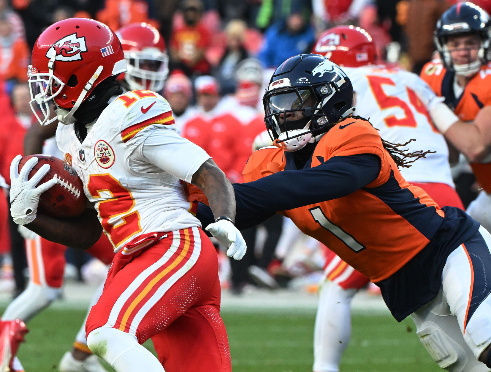 Denver Broncos cornerback Tremon Smith (1) goes after Kansas City Chiefs wide receiver Mecole Hardman Jr. after a punt during a game at Empower Field at Mile High on Sunday, Oct. 30, 2023. The Broncos defeated the Chiefs 24-9. (Photo by Jerilee Bennett, The Gazette)