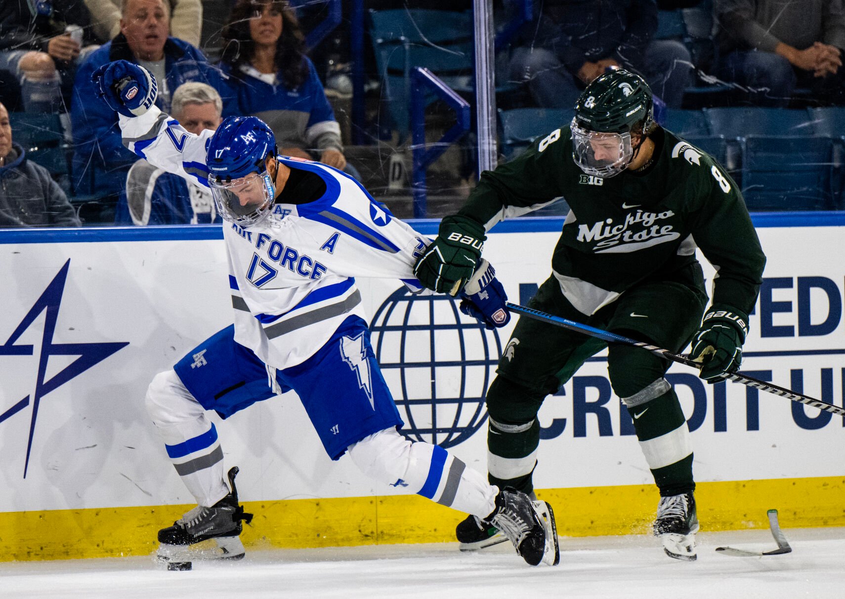 Michigan St. defenseman Maxim Štrbák (8) grabs Air Force forward Parker Brown (17) after knocking his stick out of his hands in the third period of a game Thursday, Oct. 12, 2023, at the Cadet Ice Arena on the Air Force Academy in Colorado Springs, Colo. (Parker Seibold, The Gazette) (Parker Seibold)