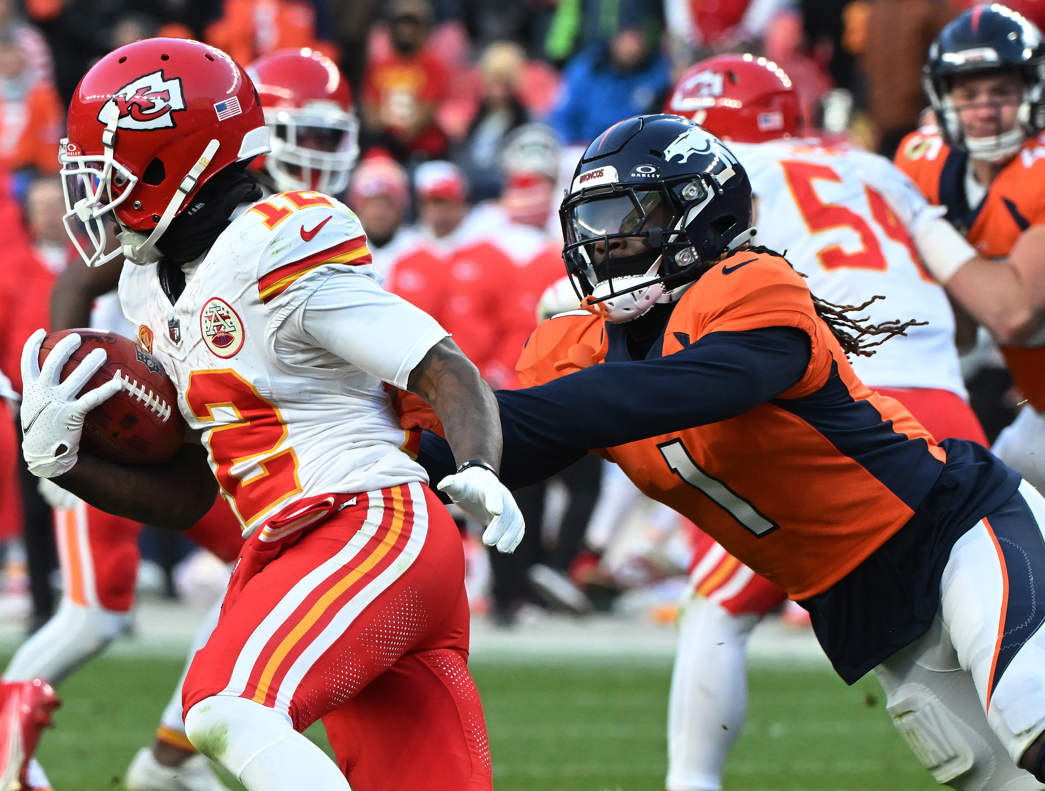 Denver Broncos cornerback Tremon Smith (1) goes after Kansas City Chiefs wide receiver Mecole Hardman Jr. after a punt during a game at Empower Field at Mile High on Sunday, Oct. 30, 2023. The Broncos defeated the Chiefs 24-9. (Photo by Jerilee Bennett, The Gazette)