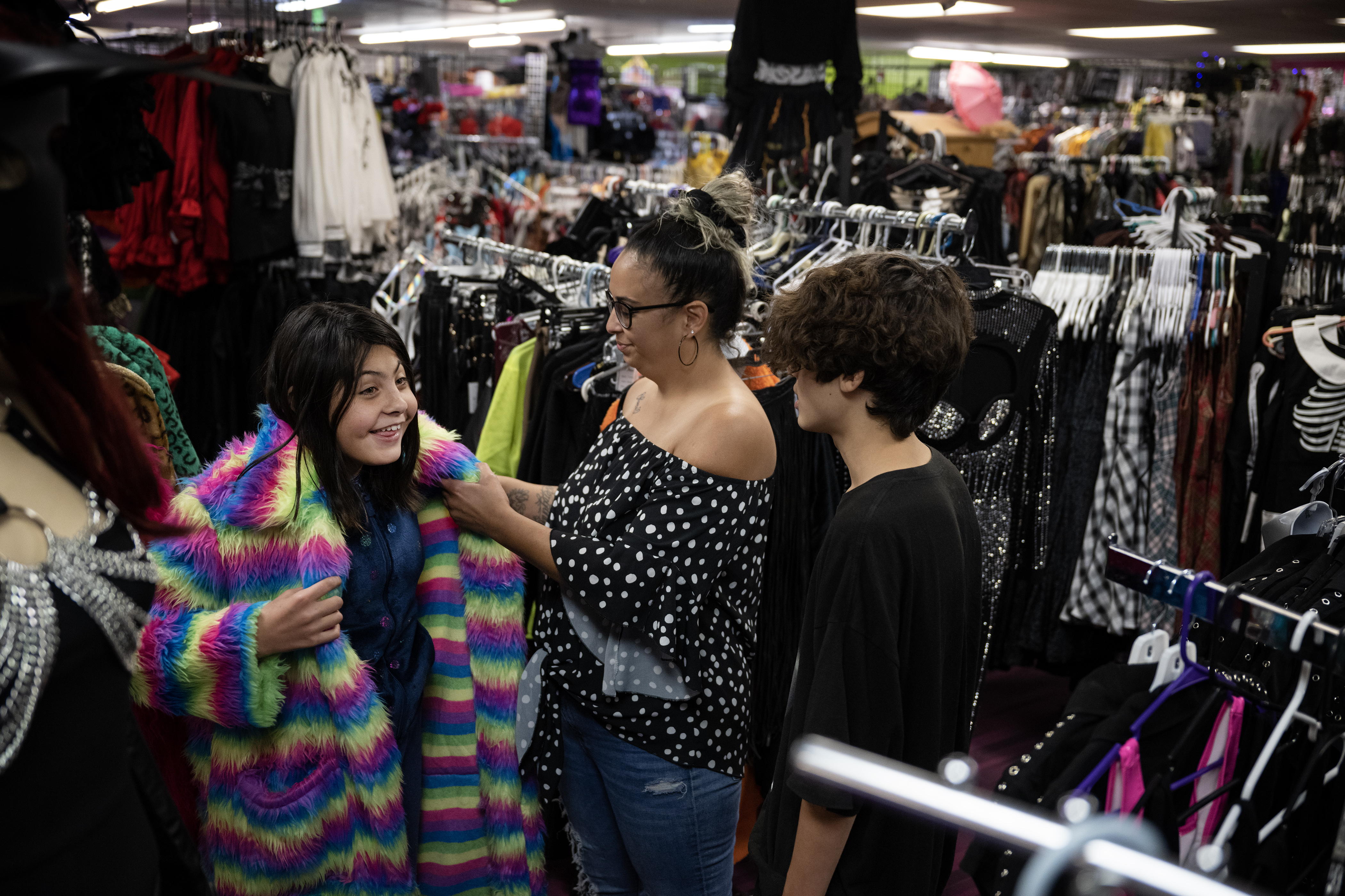Charlemae Anderson helps her daughter Charlie try on a furry coat while son Dominic looks on during a trip to Disguises A Costume Superstore on Friday, Oct. 6, 2023, in Lakewood, Colo. (Timothy Hurst/Denver Gazette) (TimHursttim.hurst@gazette.comhttps://secure.gravatar.com/avatar/aca82bd62b4ee425c598527cd6faa1b1?d=mm&r=g)