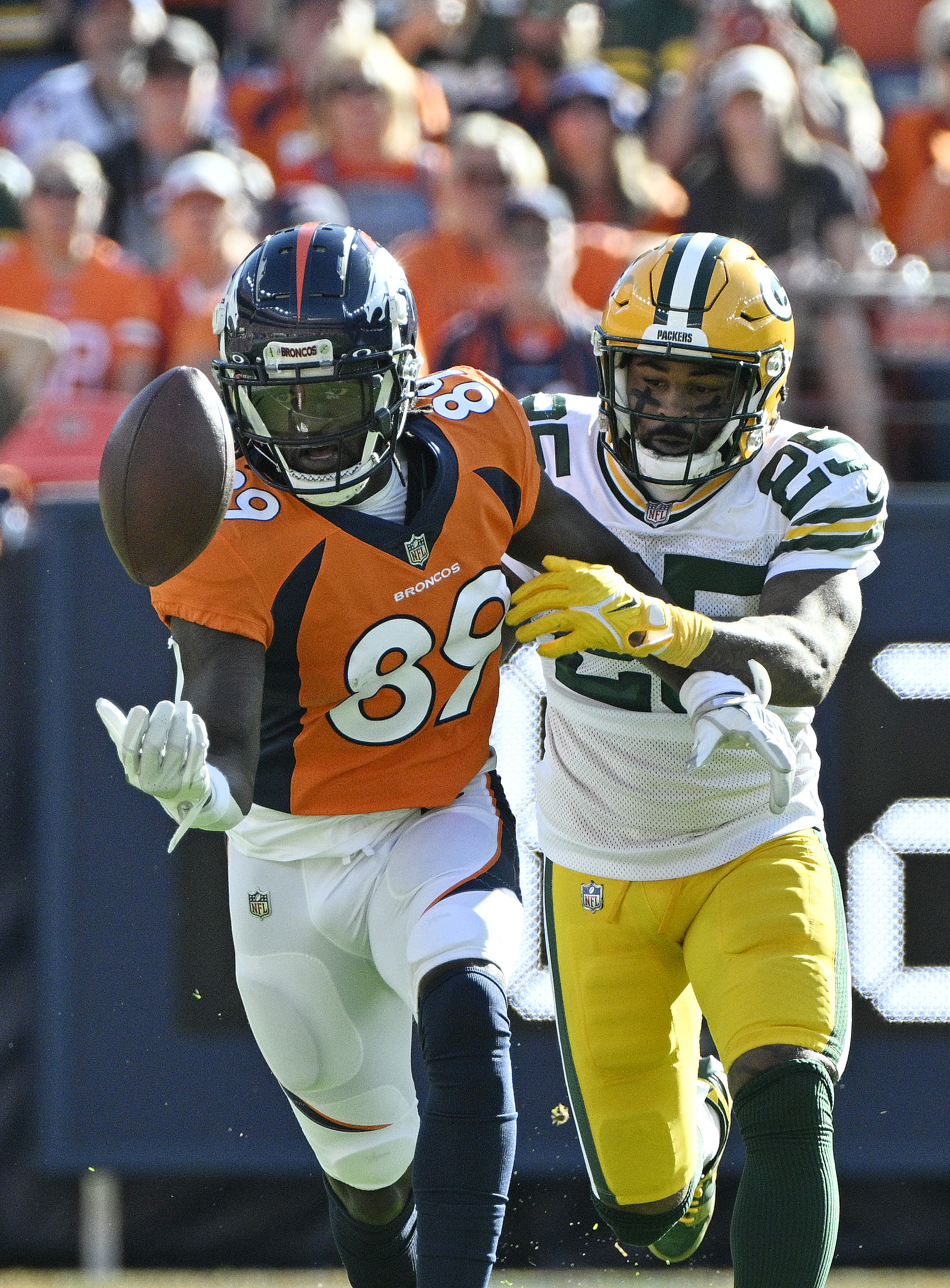 Broncos wide receiver Brandon Johnson tries to make a catch with the one hand his has open.