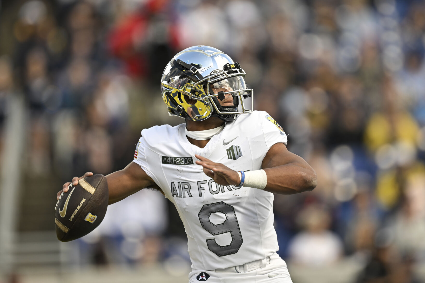 Air Force quarterback Zac Larrier (9) throws a touchdown to wide receiver Dane Kinamon against Navy, Saturday in Annapolis, Md. (the associated press)