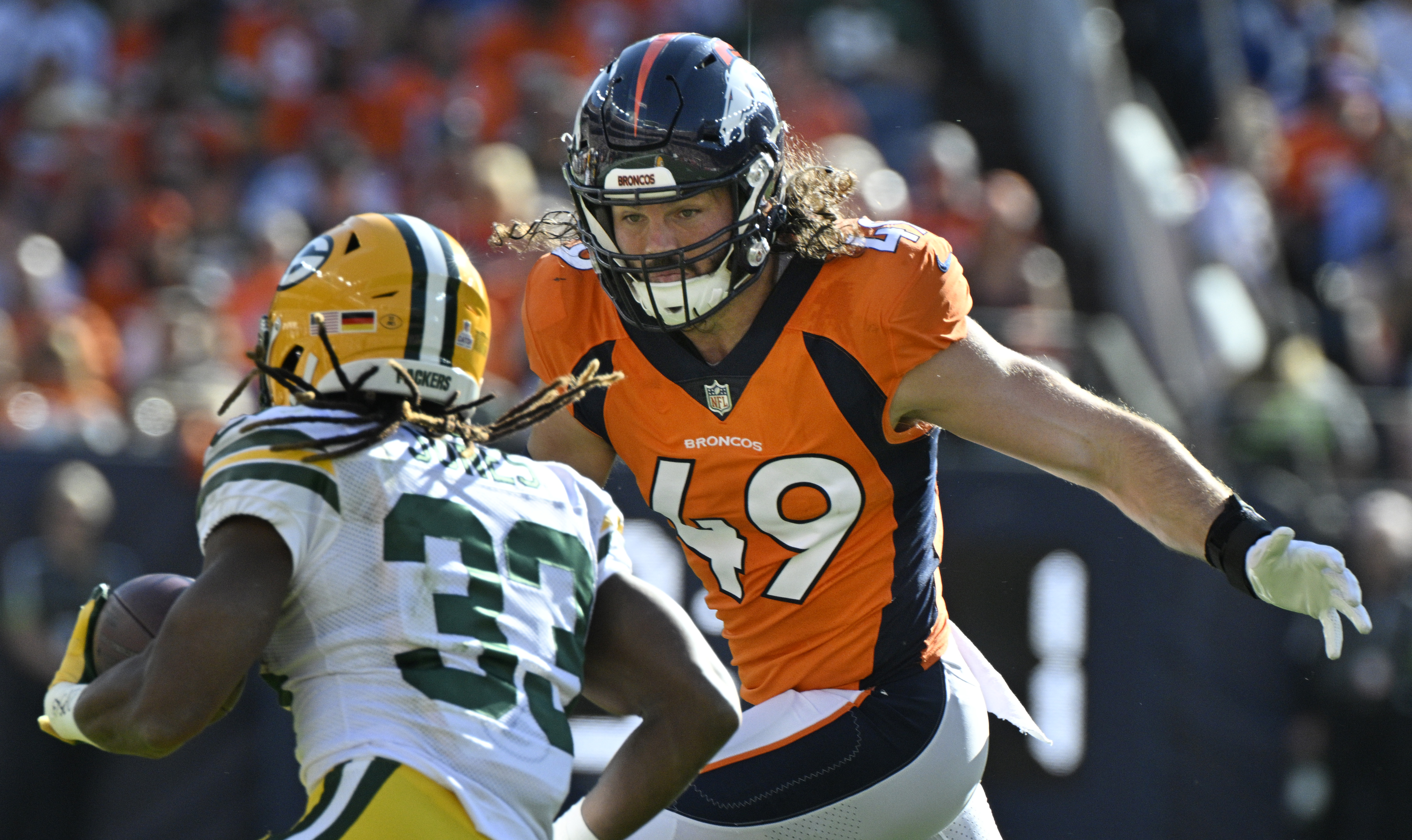 Denver Broncos linebacker Alex Singleton (49) goes after Green Bay Packers running back Aaron Jones (33) during a game at Empower Field at Mile High on Sunday, Oct. 22, 2023. (Photo by Jerilee Bennett, The Gazette)