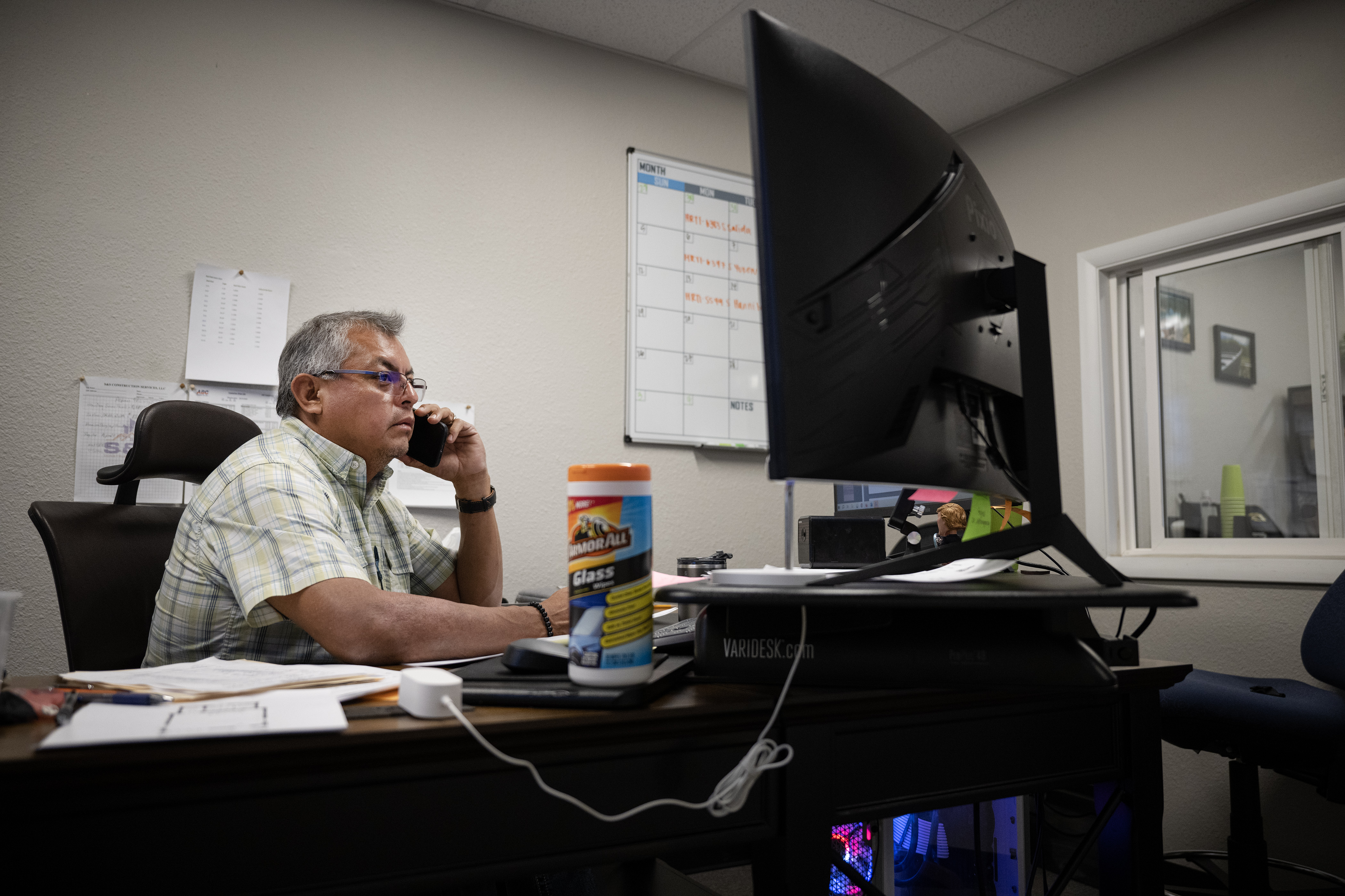 S&S Construction Services COO Sergio Sarabia talks with a client while at his desk at his and wife Gabriela’s second company , Paragon Sheetmetal and Fabrication, on Wednesday, Oct. 11, 2023, in Denver, Colo. (Timothy Hurst/Denver Gazette) (Timothy Hurst/Denver Gazette)