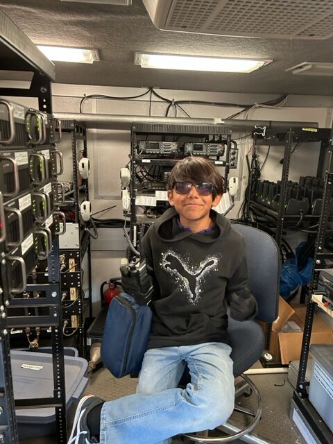 Joseph Arreguiin, a 6th grader at Denver Public School's Pitt Waller K-8 School, is at home in a mobile communications center. The Denver Police Museum started the educational school program two years ago in order to introduce students to the possibility of a job with law enforcement. (Courtesy: Mike Hesse, Denver Police Museum)