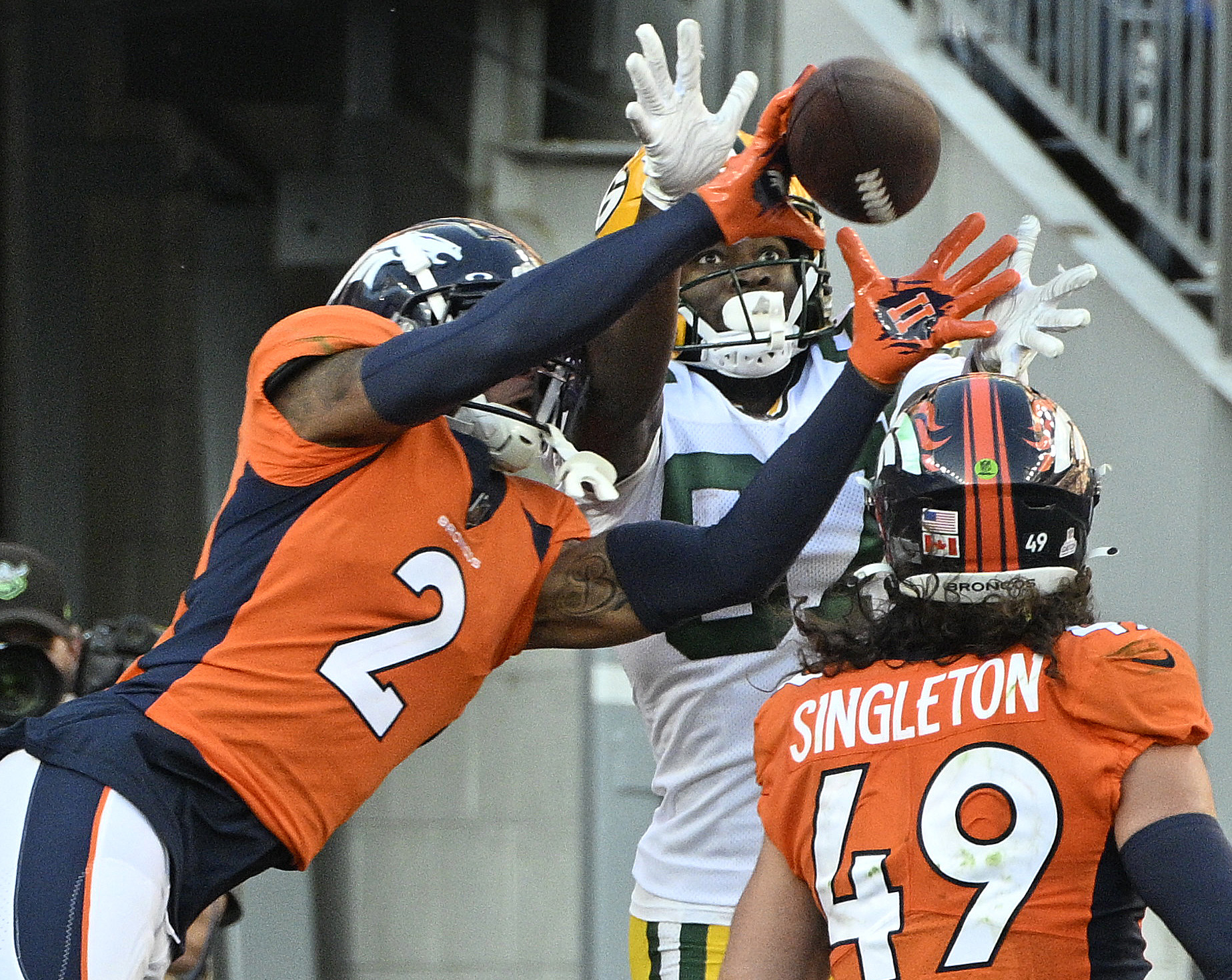 Broncos Patrick Surtain almost intercepts this touchdown pass to Packers wide receiver Romeo Doubs, but Doubs came up with the ball during the third quarter of a game at Empower Field at Mile High on Sunday, Oct. 22, 2023. (Photo by Jerilee Bennett, The Gazette)