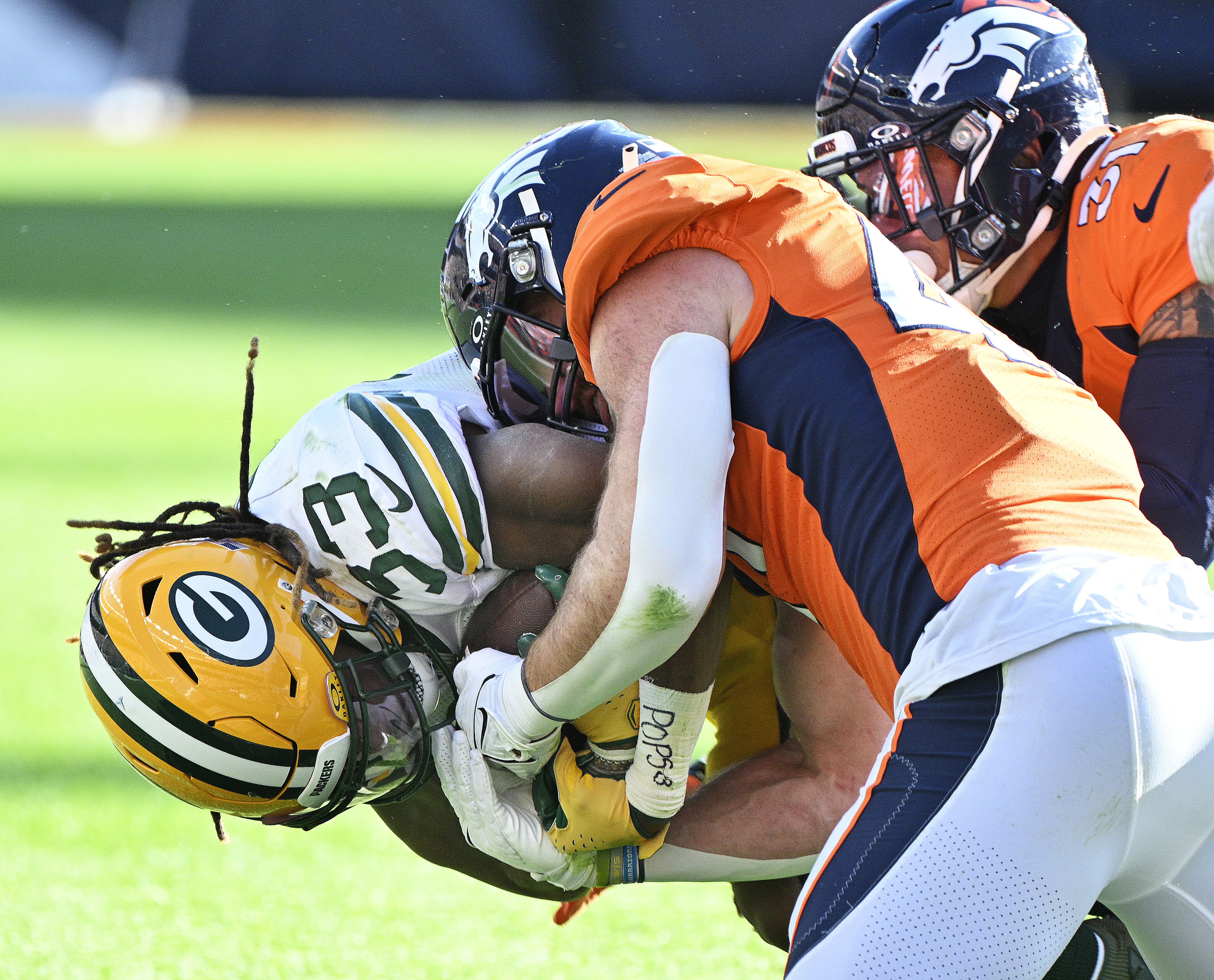 Denver Broncos linebacker Josey Jewell (47) brings down Green Bay Packers cornerback Keisean Nixon (25) during a game at Empower Field at Mile High on Sunday, Oct. 22, 2023. (Photo by Jerilee Bennett, The Gazette)