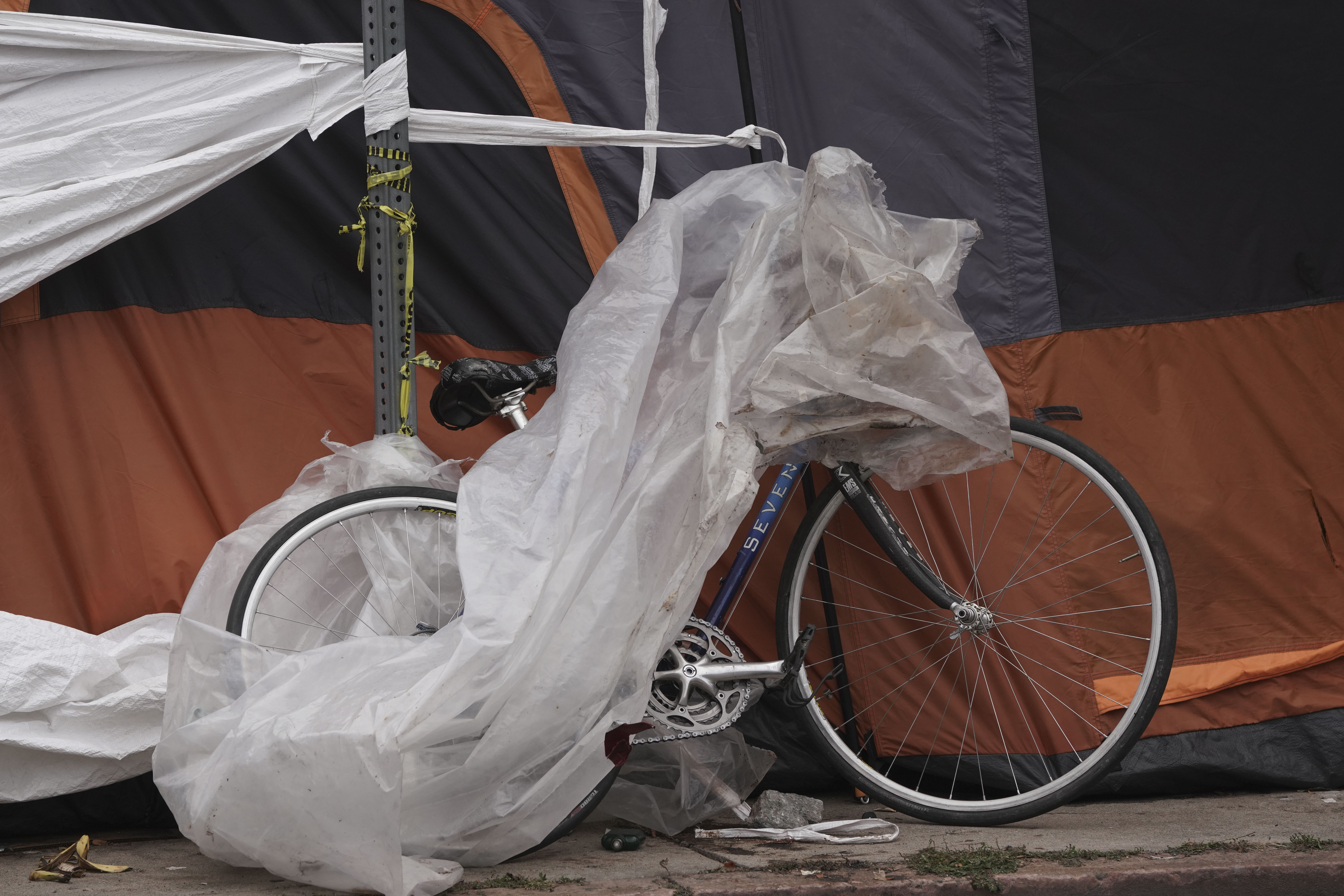 A bike rests on the side of a tent near 21st and Curtis Street on Thursday, Oct. 26, 2023 in Denver, Colorado. Some 50 homeless people at the encampment are being offered hotel housing as cold weather approaches, according to the mayor’s office. The city is planning to sweep the encampment. (PHOTO: Rebecca Slezak/Special to The Denver Gazette) (Rebecca Slezak)