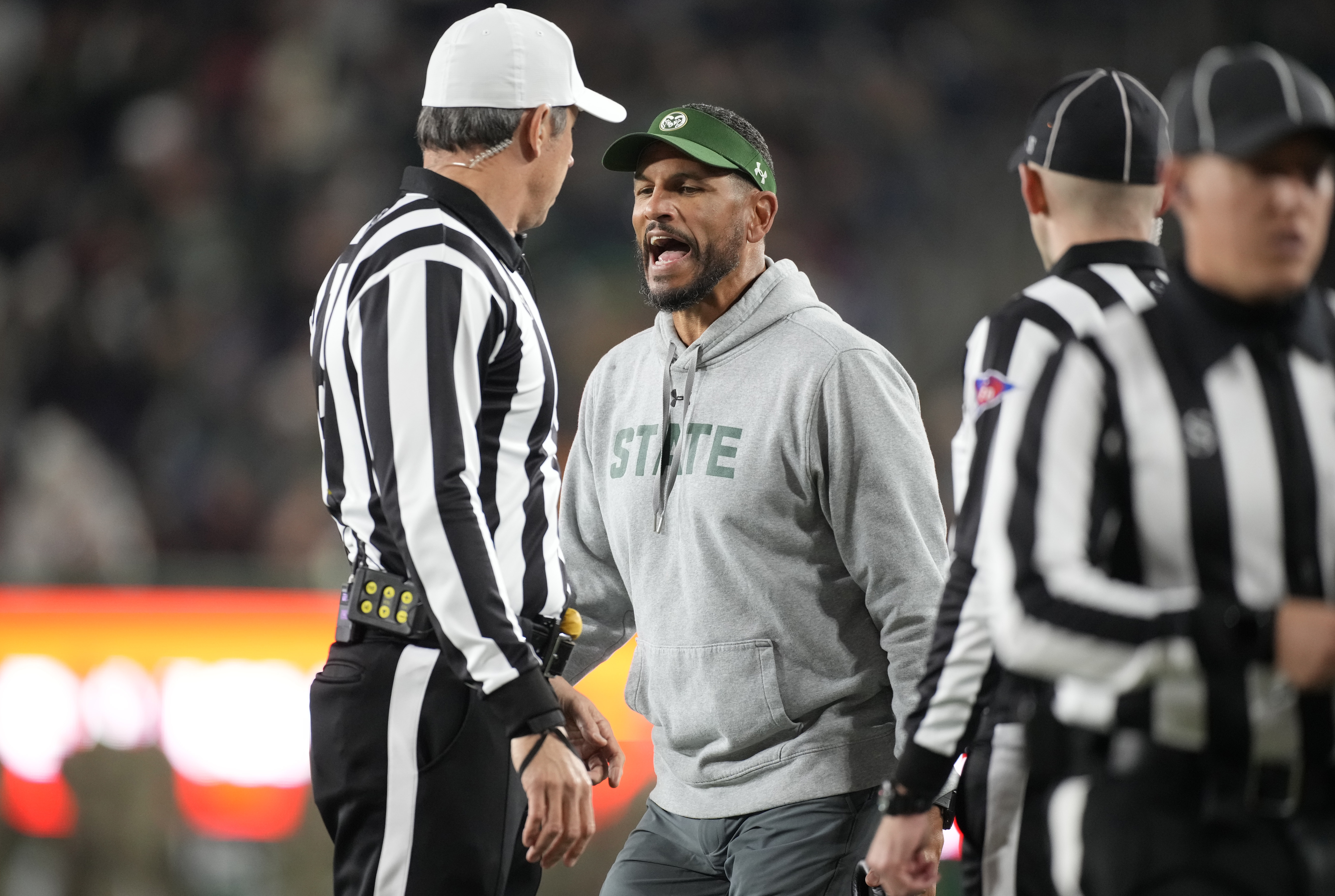 Colorado State head coach Jay Norvell, center, argues with referees in the first half of an NCAA college football game against Boise State on Saturday, Oct. 14, 2023, in Fort Collins, Colo. (AP Photo/David Zalubowski) (David Zalubowski)