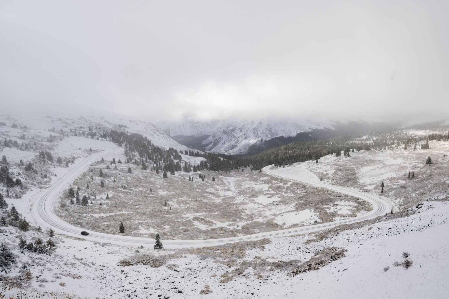 A car drives through the fresh snow on Cottonwood Pass toward Buena Vista, Colo., Tuesday, Oct. 3, 2023, after an over night snow storm cover the central mountains with snow. (The Gazette, Christian Murdock) (Christian Murdock/The Gazette)