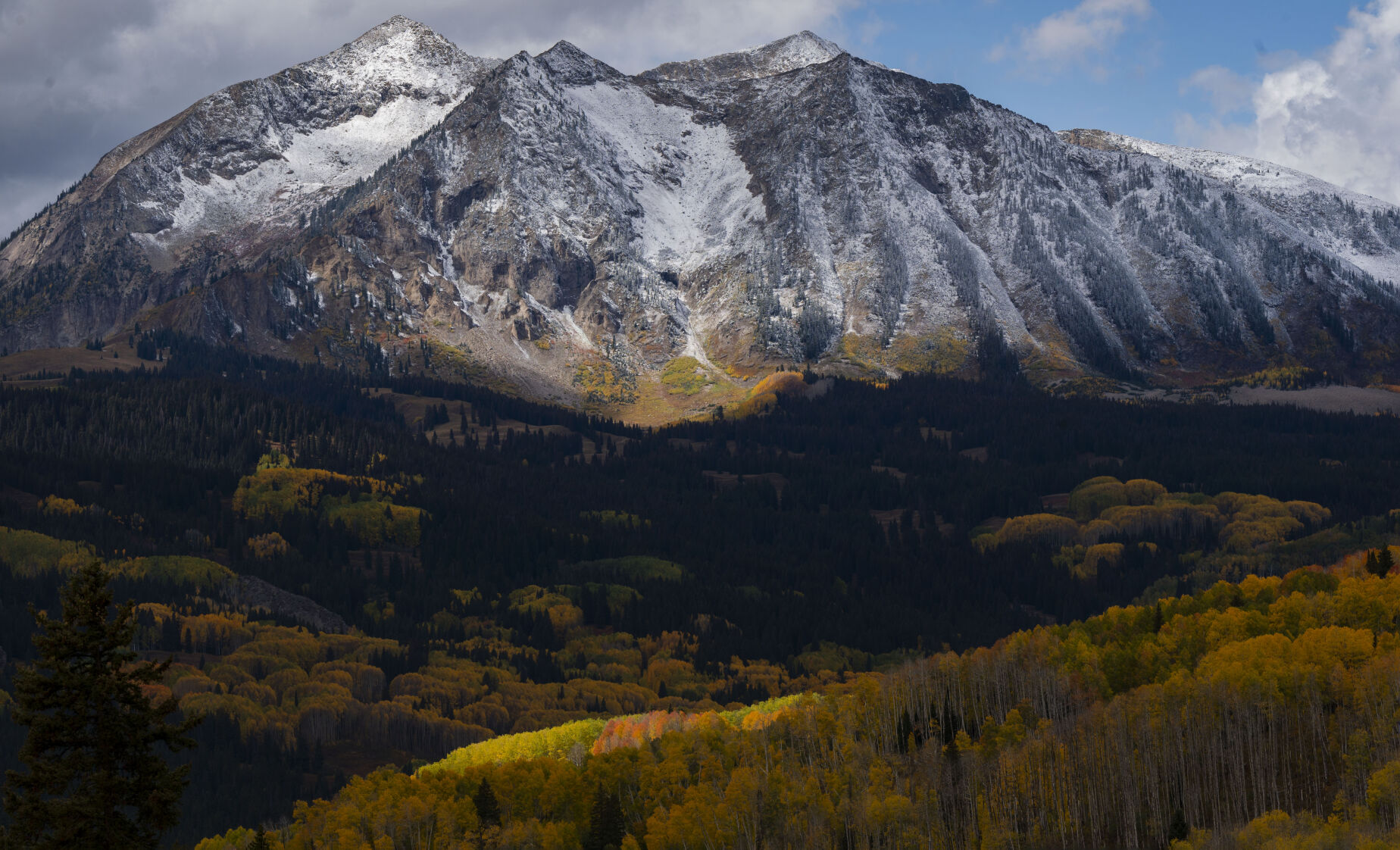 The sun spotlights a patch of turning aspens on the westside of Kebler Pass near Crested Butte, Colo., Tuesday, Oct. 3, 2023. (The Gazette, Christian Murdock) (Christian Murdock/The Gazette)
