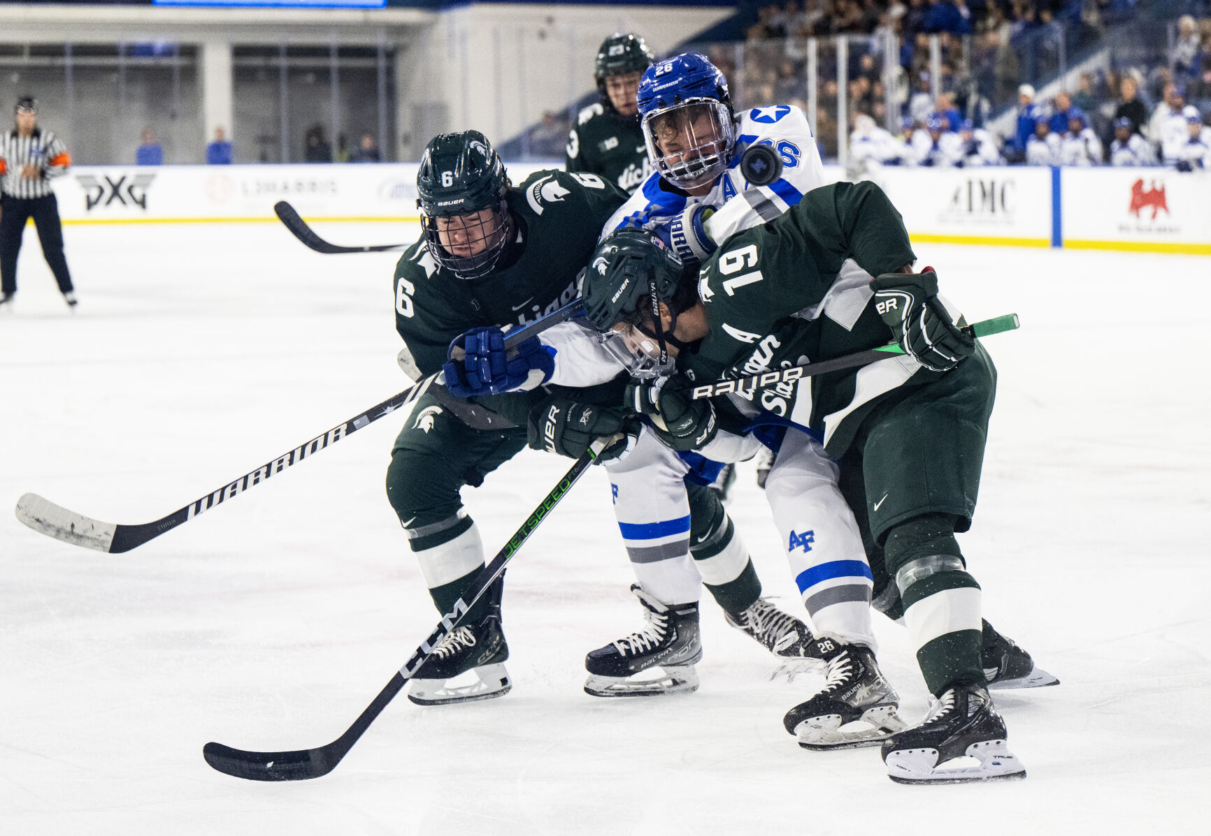 Air Force forward Clayton Cosentino (26) is sandwiched between Michigan State defenseman Austin Oravetz (6) and Michigan State forward Nicolas Muller (19) in the first period of a game Thursday, Oct. 12, 2023, at the Cadet Ice Arena on the Air Force Academy in Colorado Springs, Colo. (Parker Seibold, The Gazette) (Parker Seibold)