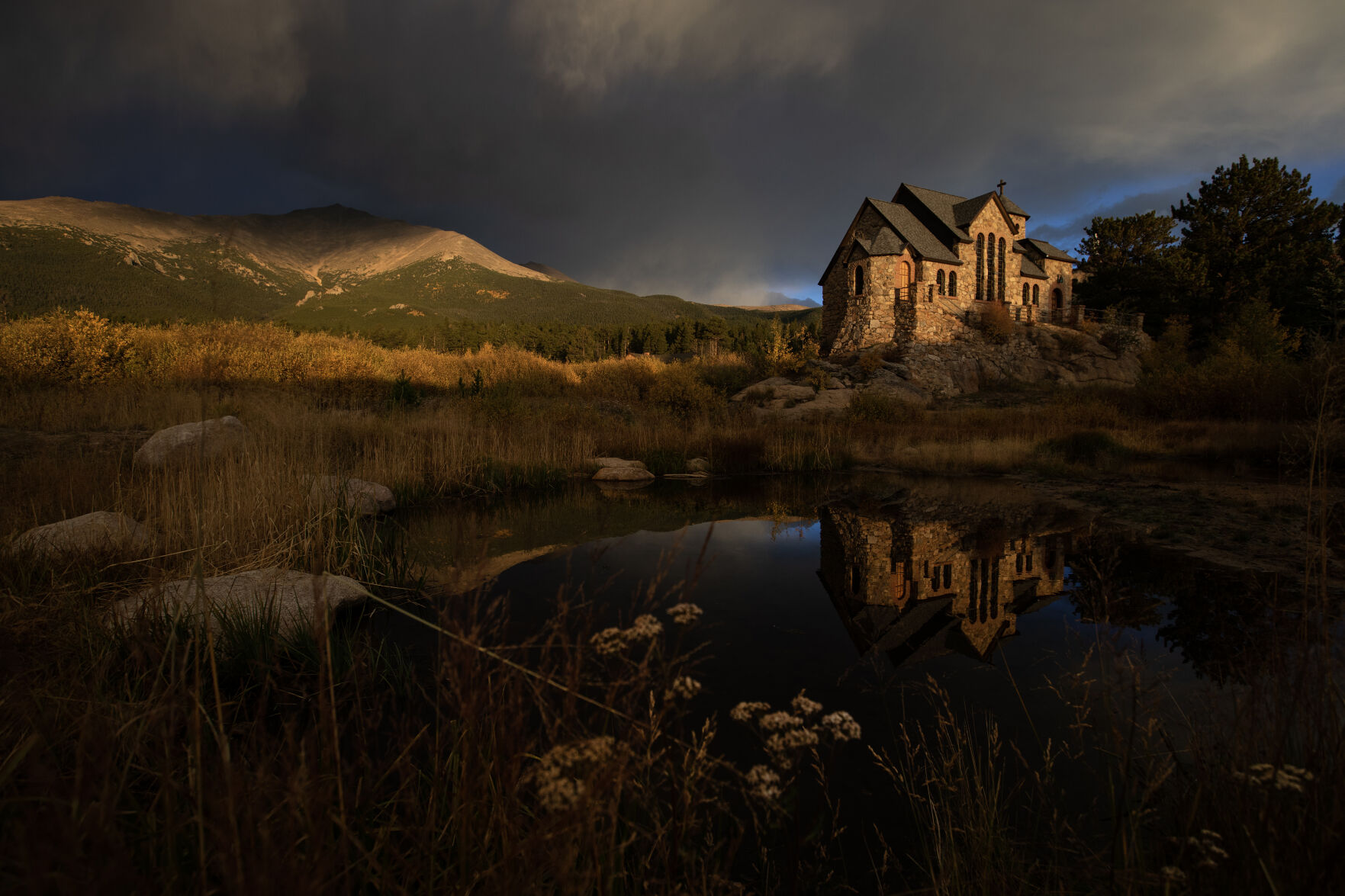 Stromclouds build over a snowcapped Mount Meeker as Saint Catherine's Chapel on the Rock is illuminated by the early morning sun on Monday, Oct. 2, 2023, in Allenspark, Colo. (Timothy Hurst/Denver Gazette) (TimHursttim.hurst@gazette.comhttps://secure.gravatar.com/avatar/aca82bd62b4ee425c598527cd6faa1b1?d=mm&r=g)