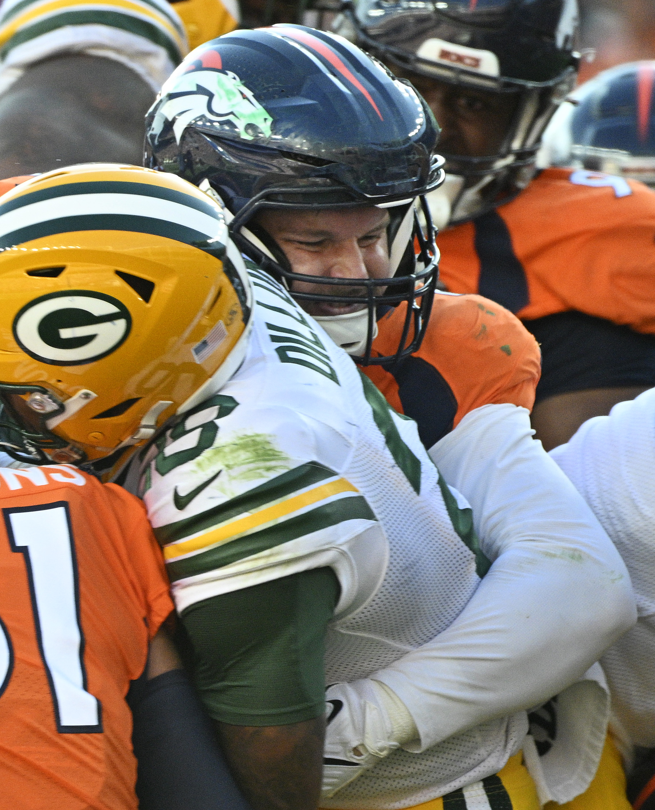 Denver Broncos defensive end Matt Henningsen (91) brings down Green Bay Packers running back AJ Dillon (28) during a game at Empower Field at Mile High on Sunday, Oct. 22, 2023. (Photo by Jerilee Bennett, The Gazette)
