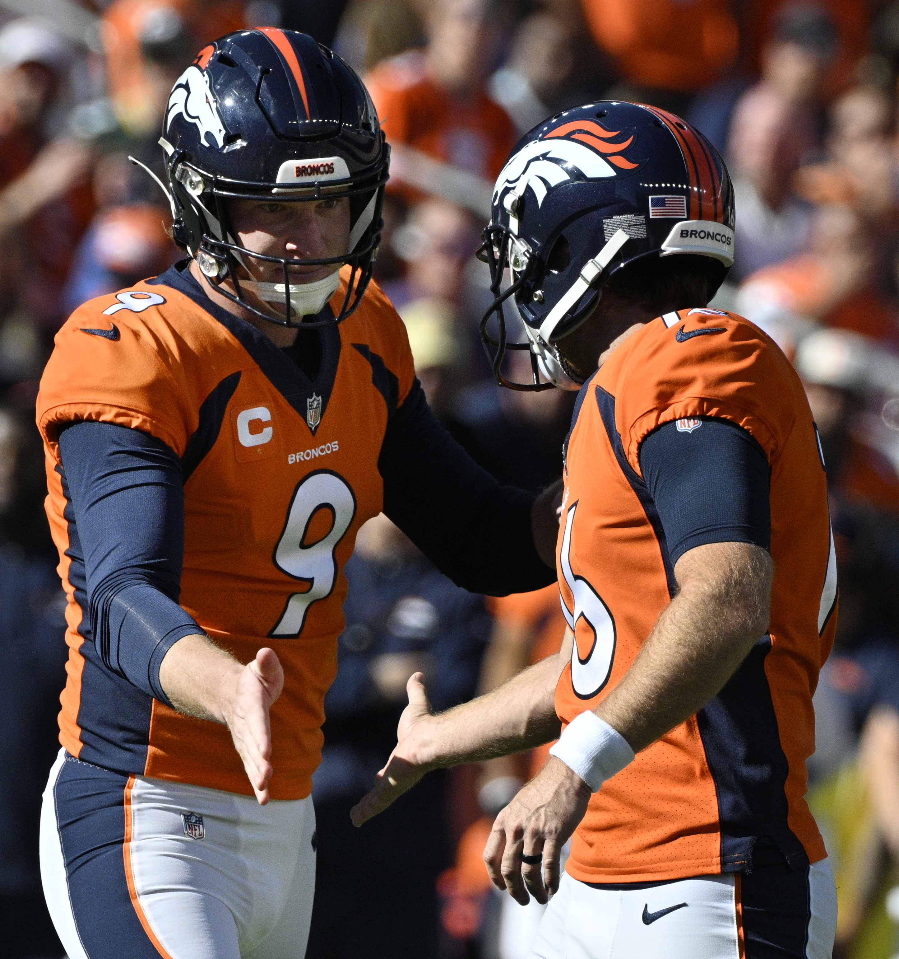 Denver Broncos punter Riley Dixon (9) congratulates Denver Broncos place kicker Wil Lutz (16) after one of his three field goals during a game at Empower Field at Mile High on Sunday, Oct. 22, 2023. (Photo by Jerilee Bennett, The Gazette)