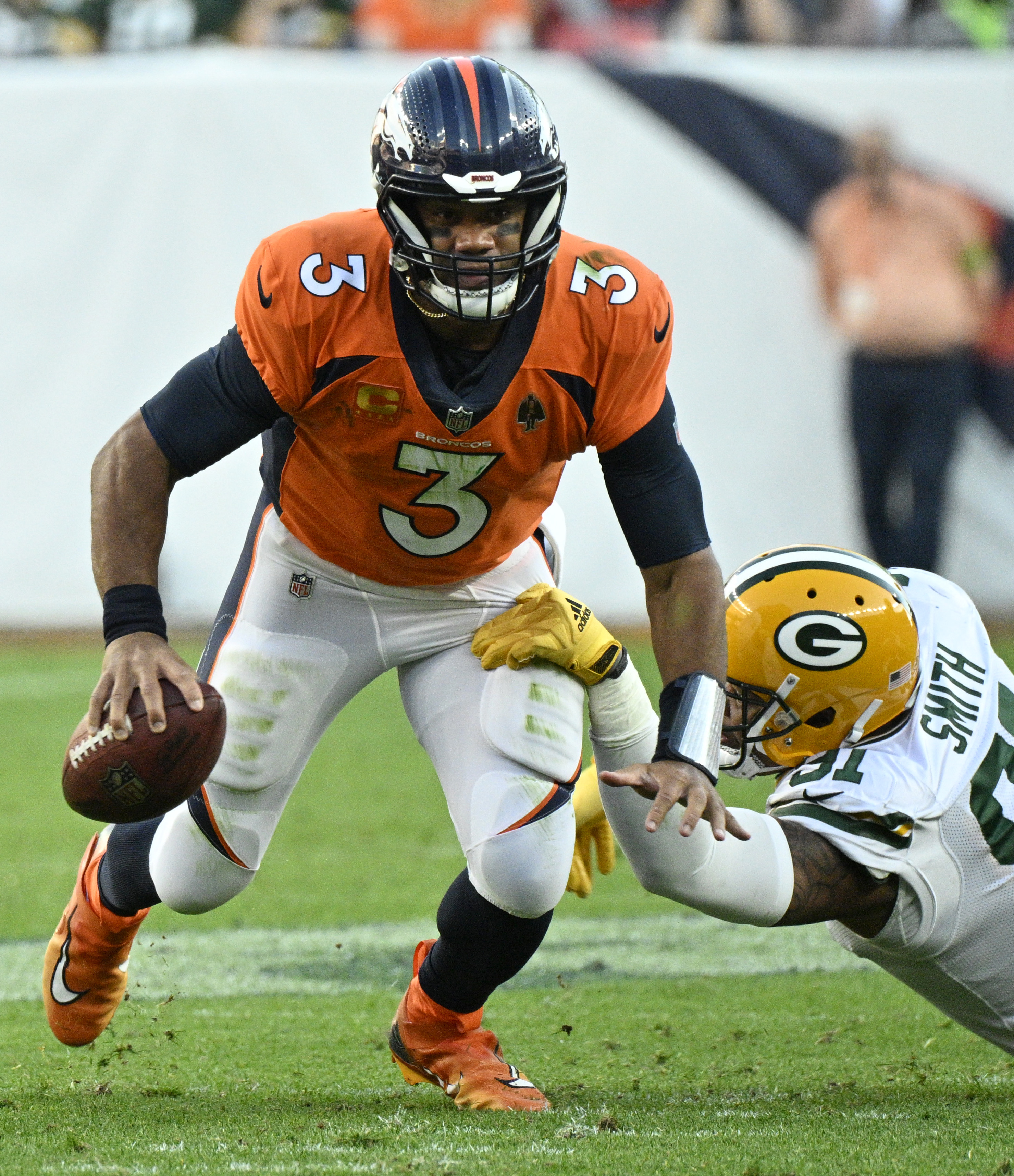 Broncos quarterback Russell Wilson scrambles for more yards during a game against the Packers at Empower Field at Mile High on Sunday, Oct. 22, 2023. (Photo by Jerilee Bennett, The Gazette)