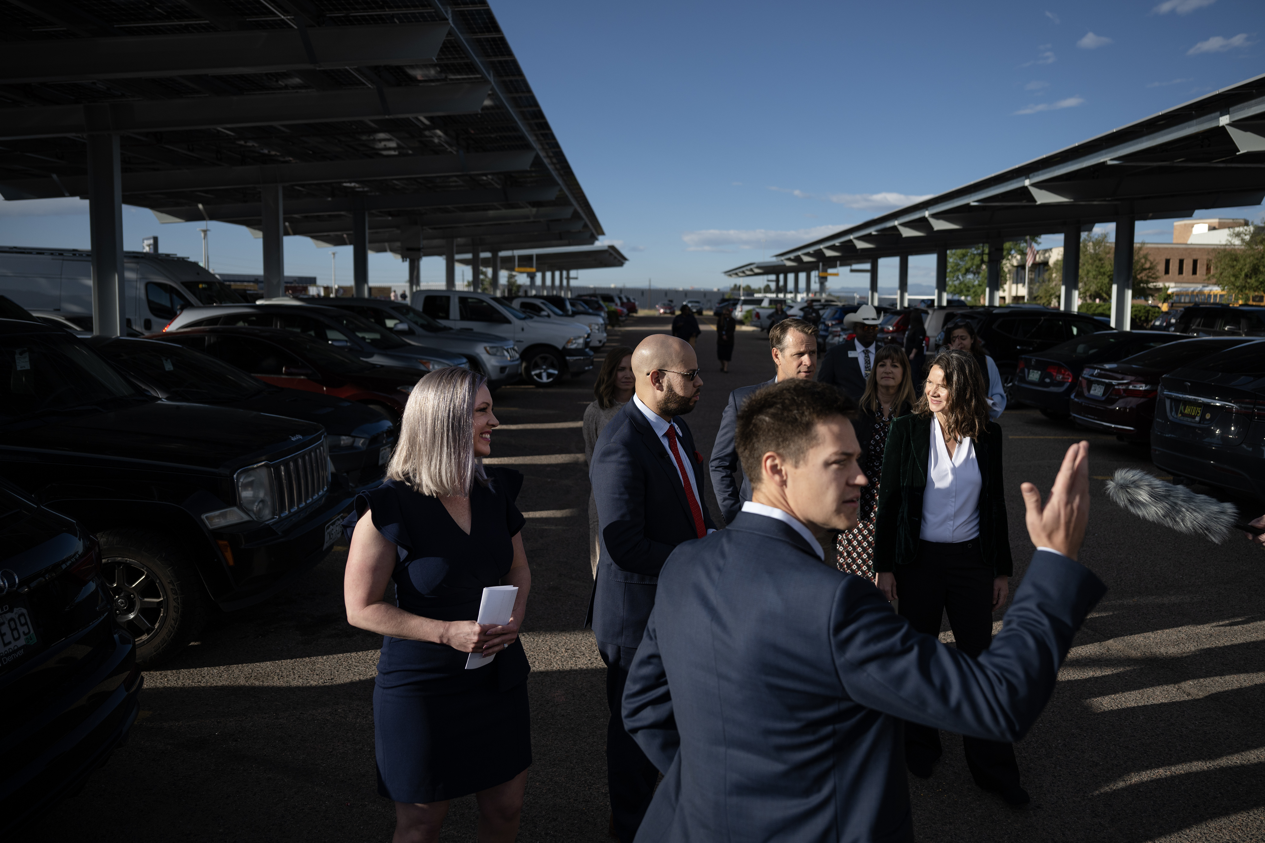 Jonathan Rogers, front, with the city of Denver, leads, from left, Principal Jennifer Warren, Denver Public Schools Superintendent Alex Marrero and Denver Office of Climate Action Sustainability and Resiliency Executive Director Elizabeth Babcock during a tour of a new solar carport in the parking lot of Northeast Early College High School before a ribbon cutting on Wednesday, Oct. 11, 2023, in Denver. (Timothy Hurst/Denver Gazette) (Timothy Hurst/Denver Gazette)