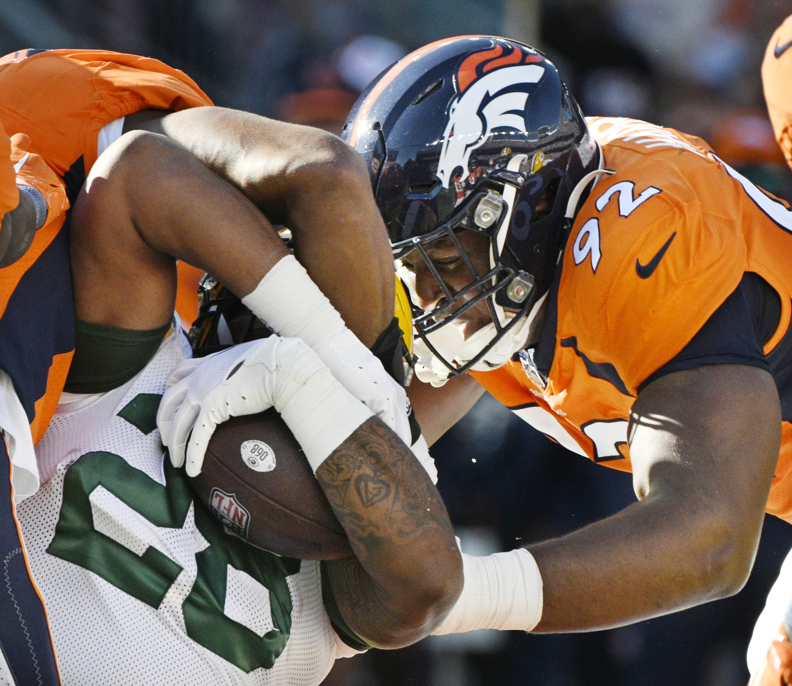 Denver Broncos defensive tackle Jonathan Harris (92) tackles Green Bay Packers running back AJ Dillon (28) during a game at Empower Field at Mile High on Sunday, Oct. 22, 2023. (Photo by Jerilee Bennett, The Gazette)