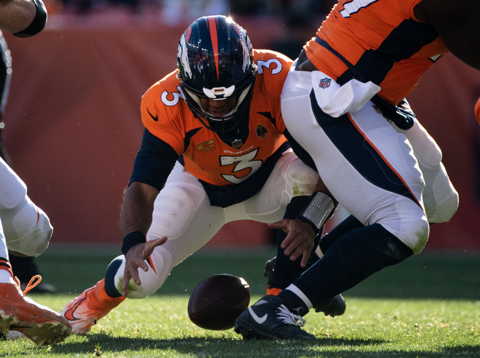 Denver Broncos quarterback Russell Wilson (3) fumbles and then recovers the ball in the first half of a game on Sunday, Nov. 26, 2023, at Empower Field at Mile High in Denver, Colo. (Parker Seibold, The Gazette) (Parker Seibold)