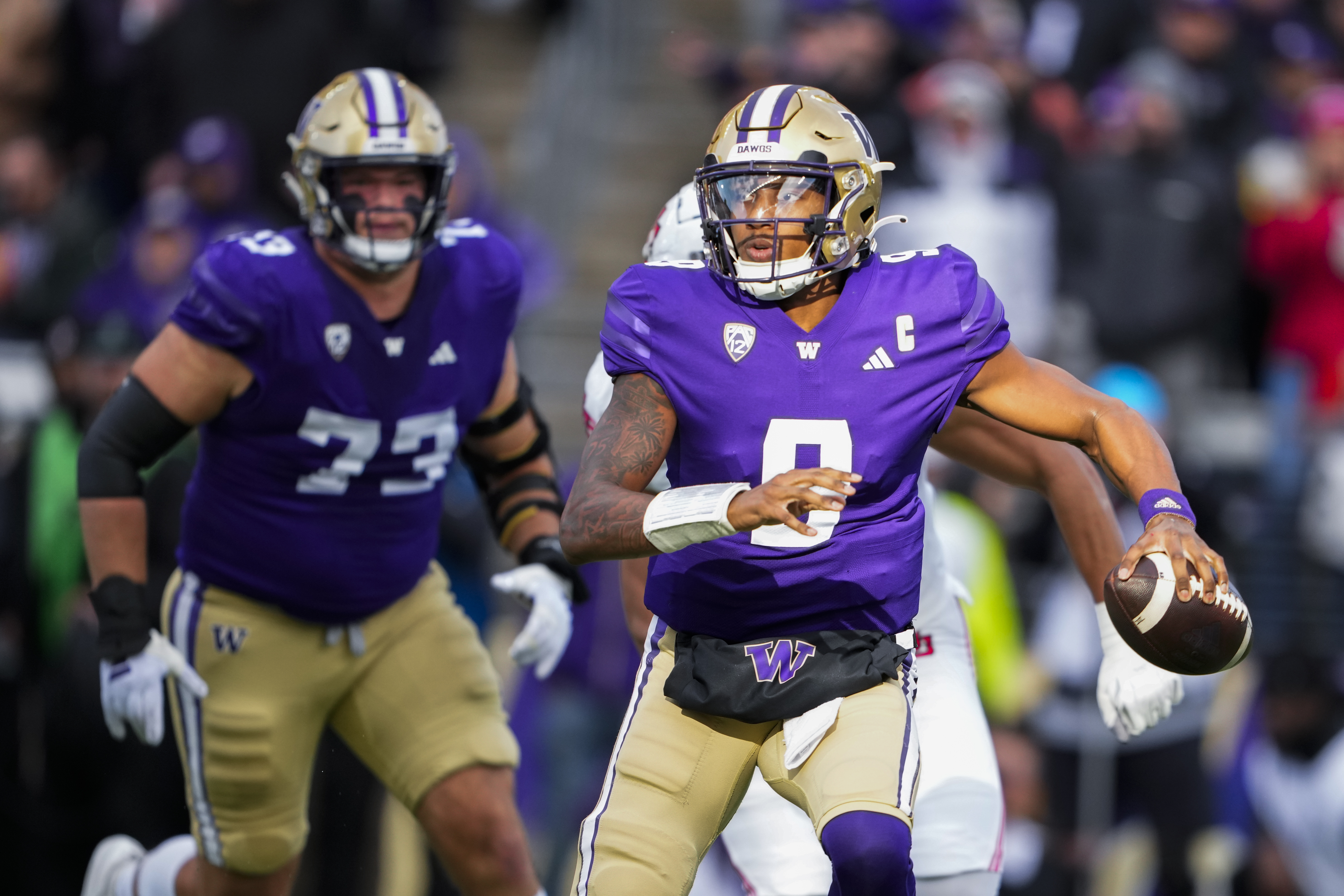 Washington quarterback Michael Penix Jr. (9) runs with the ball as he looks to pass during the first half of an NCAA college football game against Utah, Saturday, Nov. 11, 2023, in Seattle. (AP Photo/Lindsey Wasson) (Lindsey Wasson)