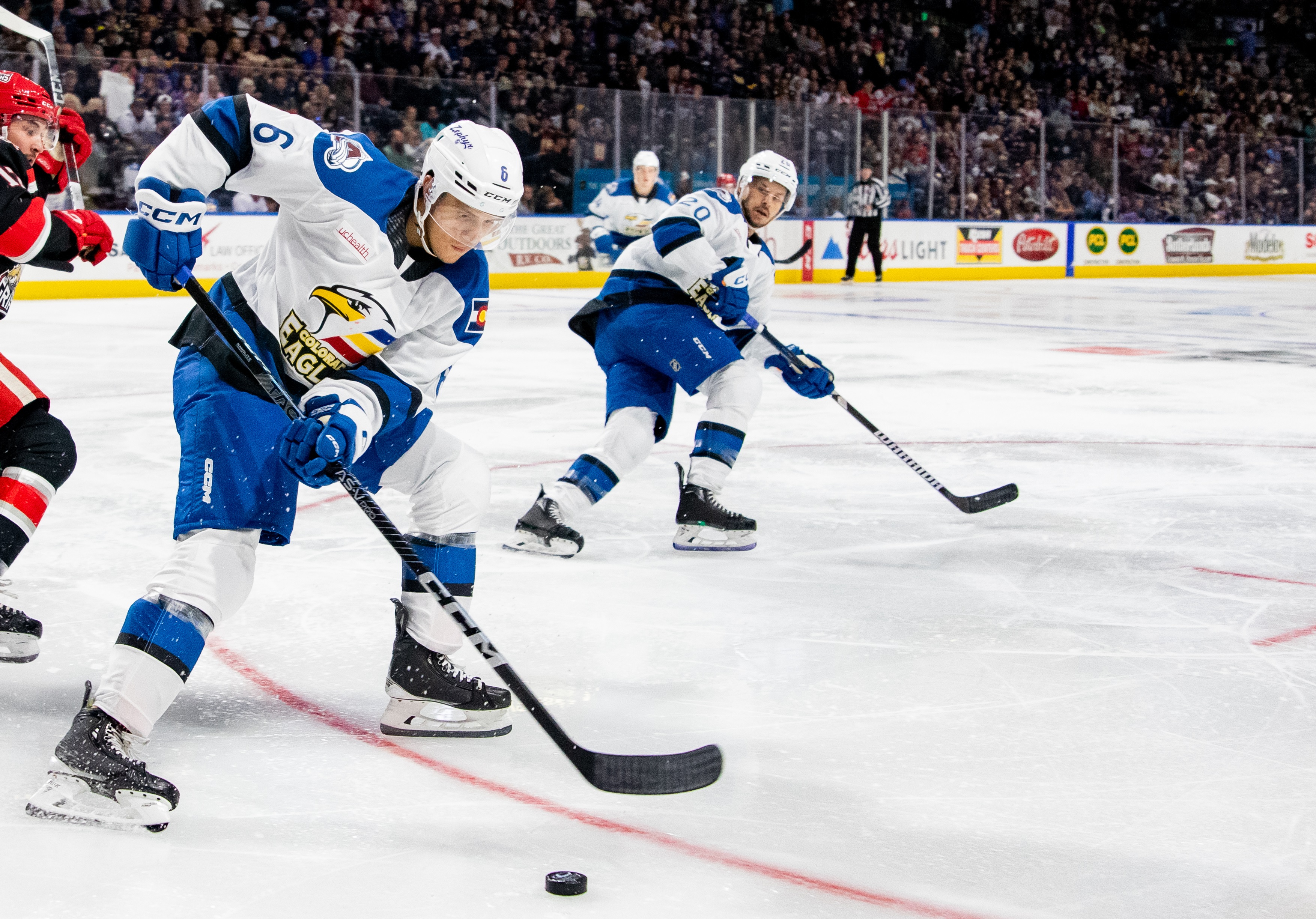 Colorado Eagles defenseman Caleb Jones (left) clears the zone in a recent AHL game at Blue Arena in Loveland, Colo. The Colorado Avalanche recalled Jones to the NHL roster on Saturday. (Courtesy of Katie Florio/Colorado Eagles)
