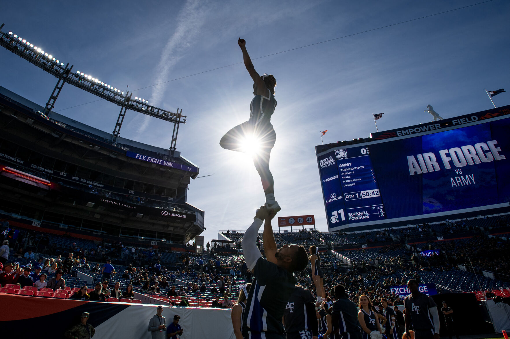 Air Force cheerleaders Martin Smith, bottom, and Courtney Davis do a stunt before an NCAA college football game on Saturday, Nov. 4, 2023, at Empower Field at Mile High in Denver, Colo. (Parker Seibold, The Gazette) (Parker Seibold)