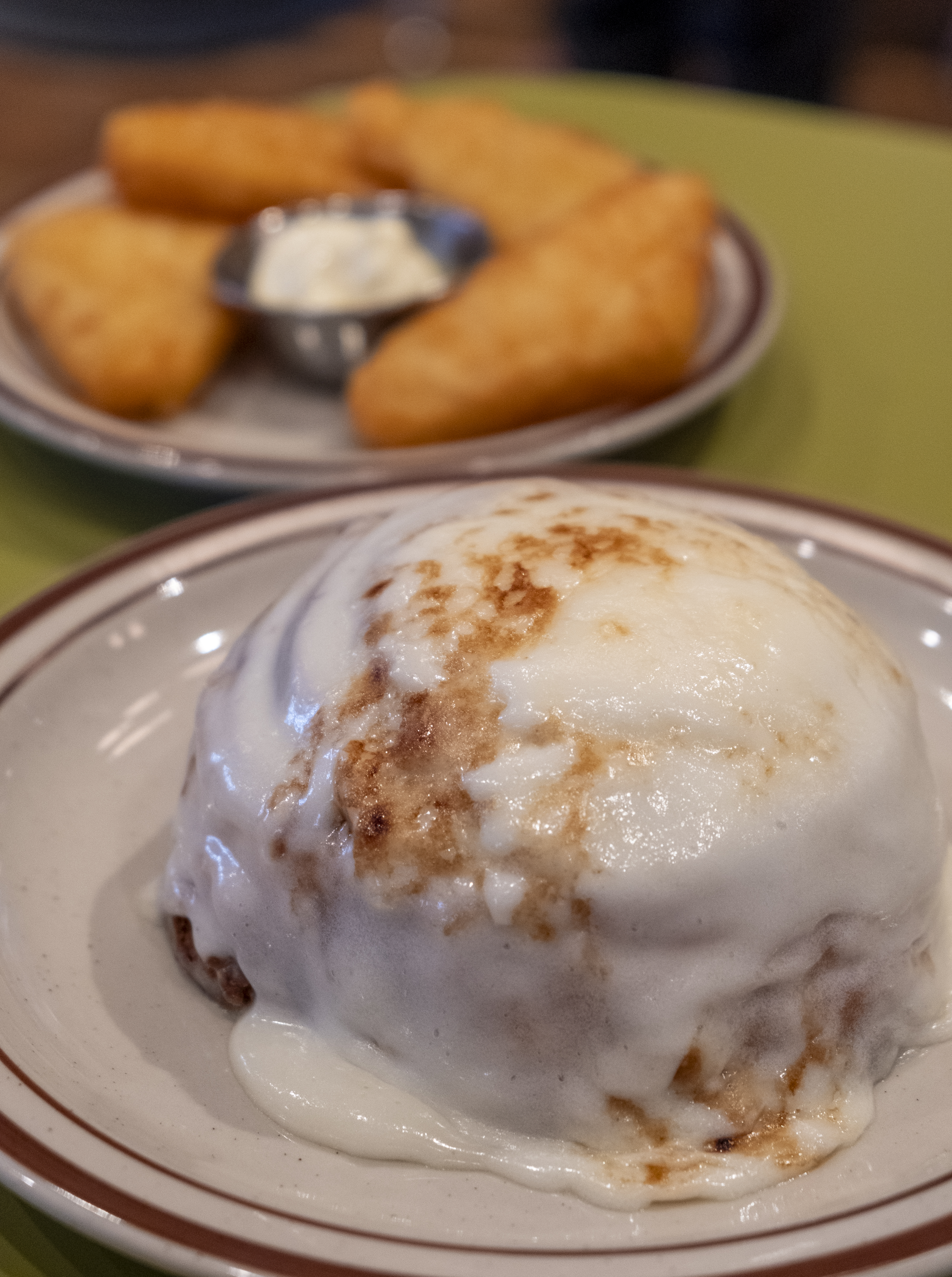 A cinnamon roll, front, and has browns, as seen Wednesday, Nov. 8, 2023, are two offerings the Atomic Cowboy restaurant has on its menu. The newest Atomic Cowboy restaurant opened its doors in late-October 2023 in downtown Golden, Colorado. (JonathanIngrahamDigital Strategistjonathan.ingraham@denvergazette.comhttps://denvergazette.com/content/tncms/avatars/c/dd/7f0/cdd7f086-b693-11ec-b373-bba598953eb6.fc0f5608a6f1144f64f080f771bd904d.png)