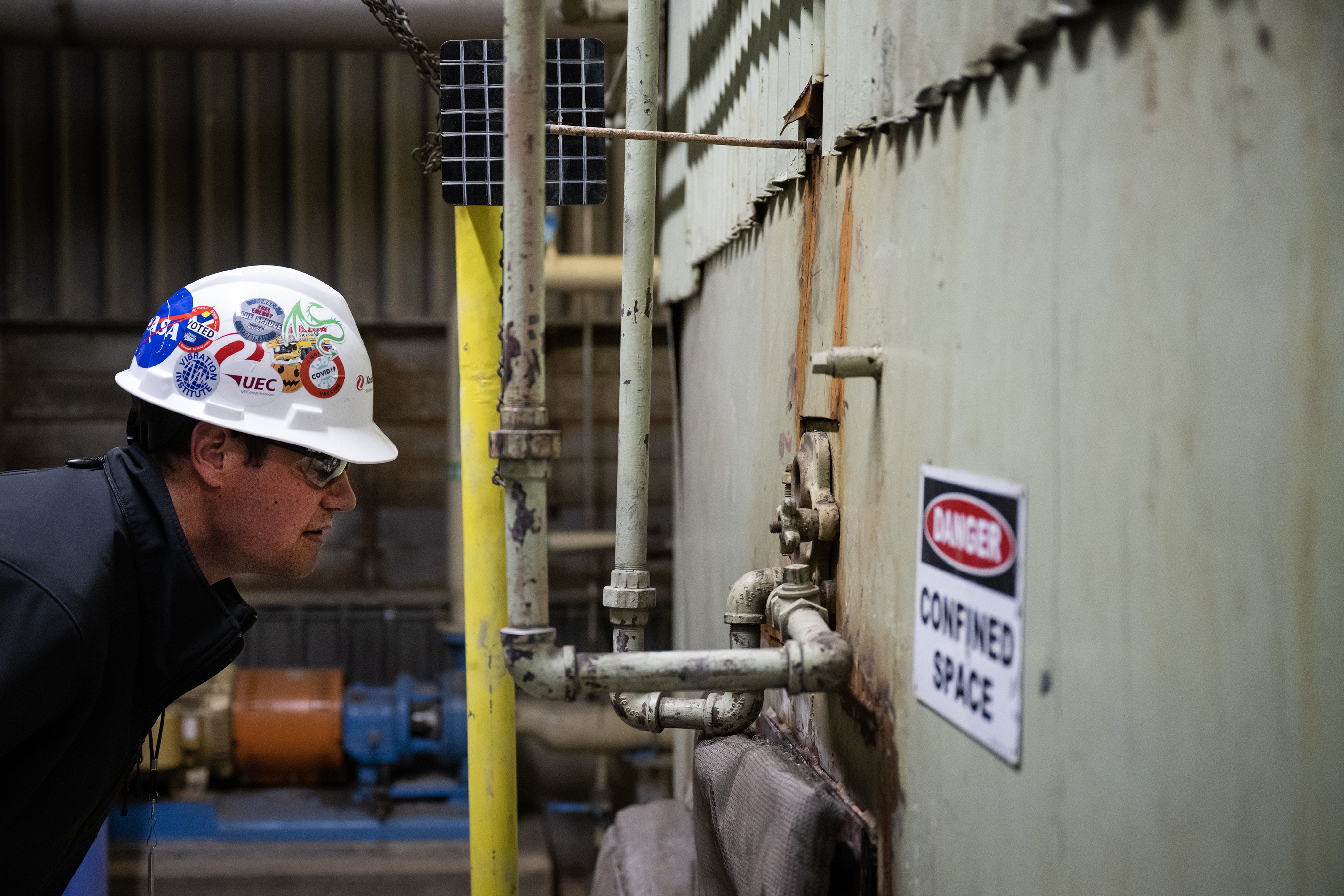 Xcel Energy business development analyst Joe Schwark looks into the sight glass of the number two boiler to see if its burner is lit while giving a tour of the facility on Wednesday, Nov. 15, 2023, at the Xcel Energy Denver Steam Plant in Denver, Colo. (Timothy Hurst/Denver Gazette) (TimHursttim.hurst@gazette.comhttps://secure.gravatar.com/avatar/aca82bd62b4ee425c598527cd6faa1b1?d=mm&r=g)