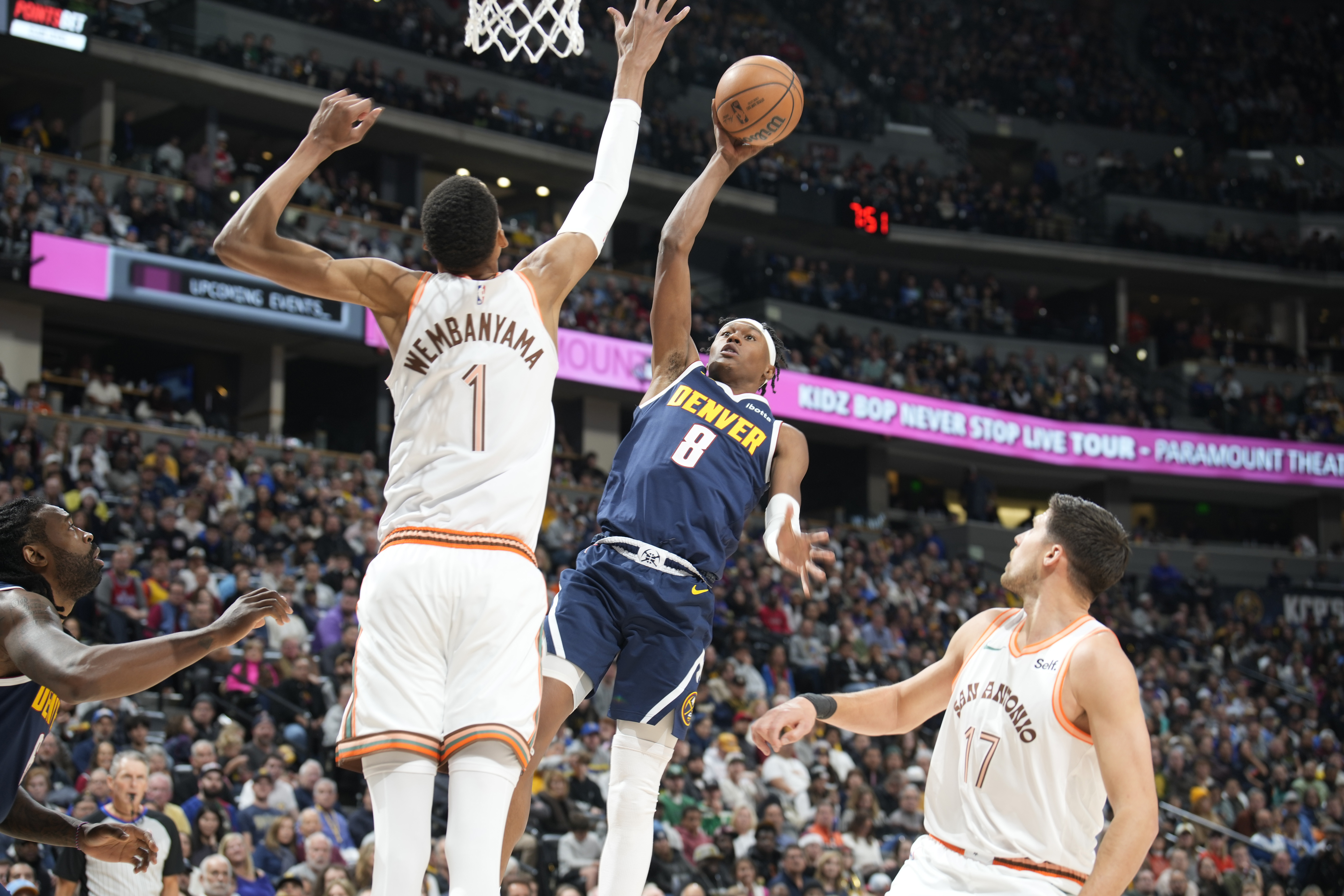 Denver Nuggets forward Peyton Watson (8) drives to the basket as San Antonio Spurs center Victor Wembanyama (1) and forward Doug McDermott, right, defend in the second half of an NBA basketball game Sunday, Nov. 26, 2023, in Denver. (AP Photo/David Zalubowski) (The Associated Press)