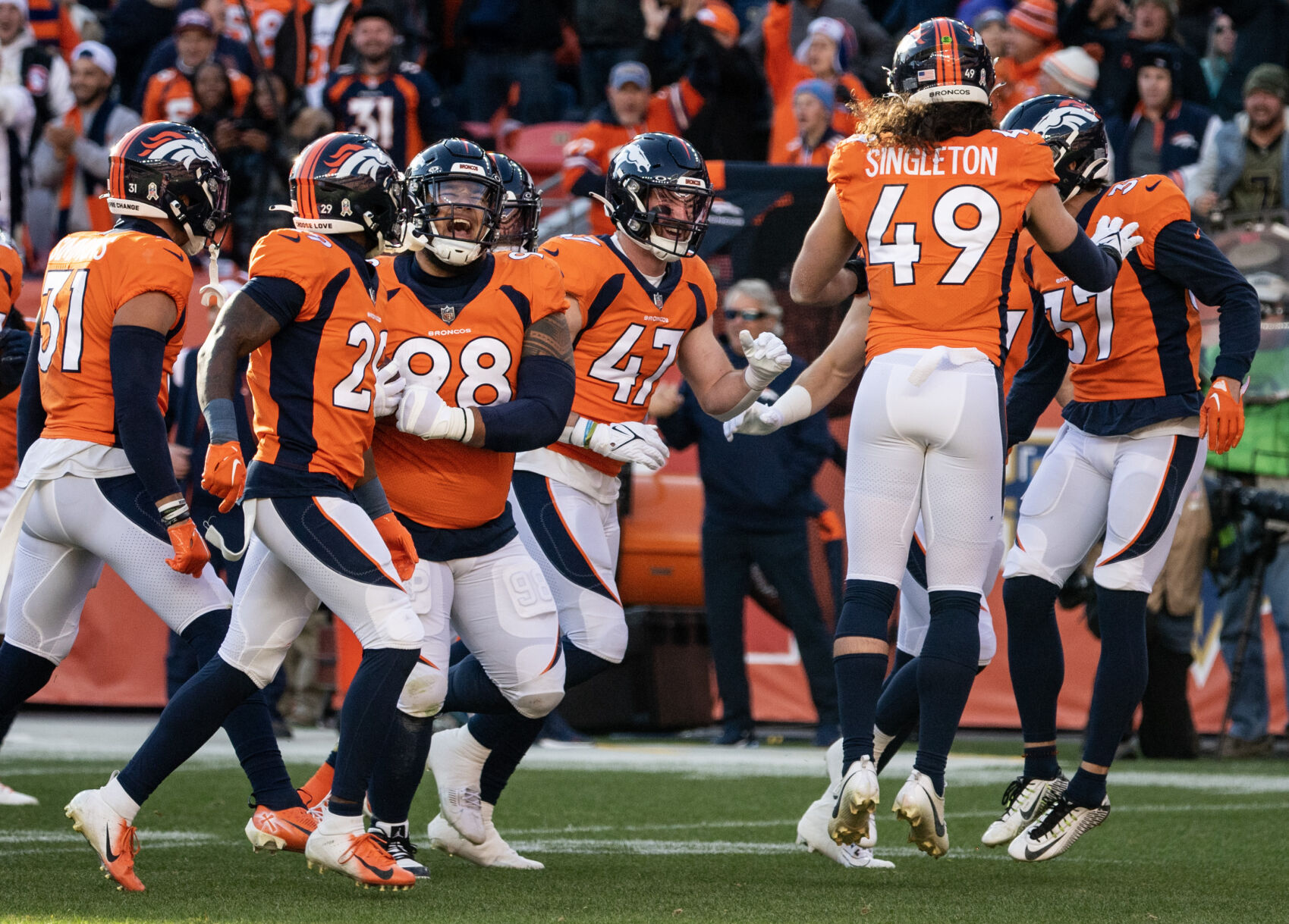 Denver Broncos defensive tackle Mike Purcell (98) celebrates with teammates after a play in the first half of a game on Sunday, Nov. 26, 2023, at Empower Field at Mile High in Denver, Colo. (Parker Seibold, The Gazette)