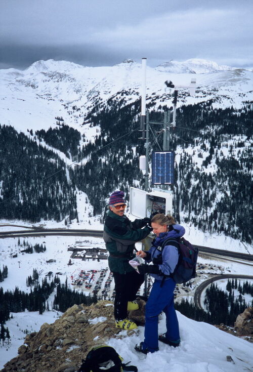 {span}The Loveland Pass station with the Loveland Ski area parking lot, Loveland Pass and I-70 in the valley below. CAIC’s Kathy Frasier and Nick Logan skied/hiked in from the ski area to troubleshoot connections with the weather station. Photo by Nick Logan{/span}